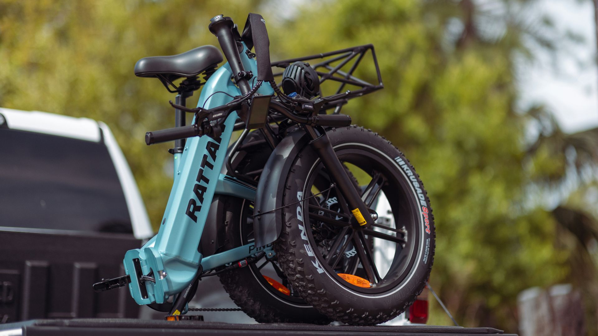 a blue bike is on the back of a truck
