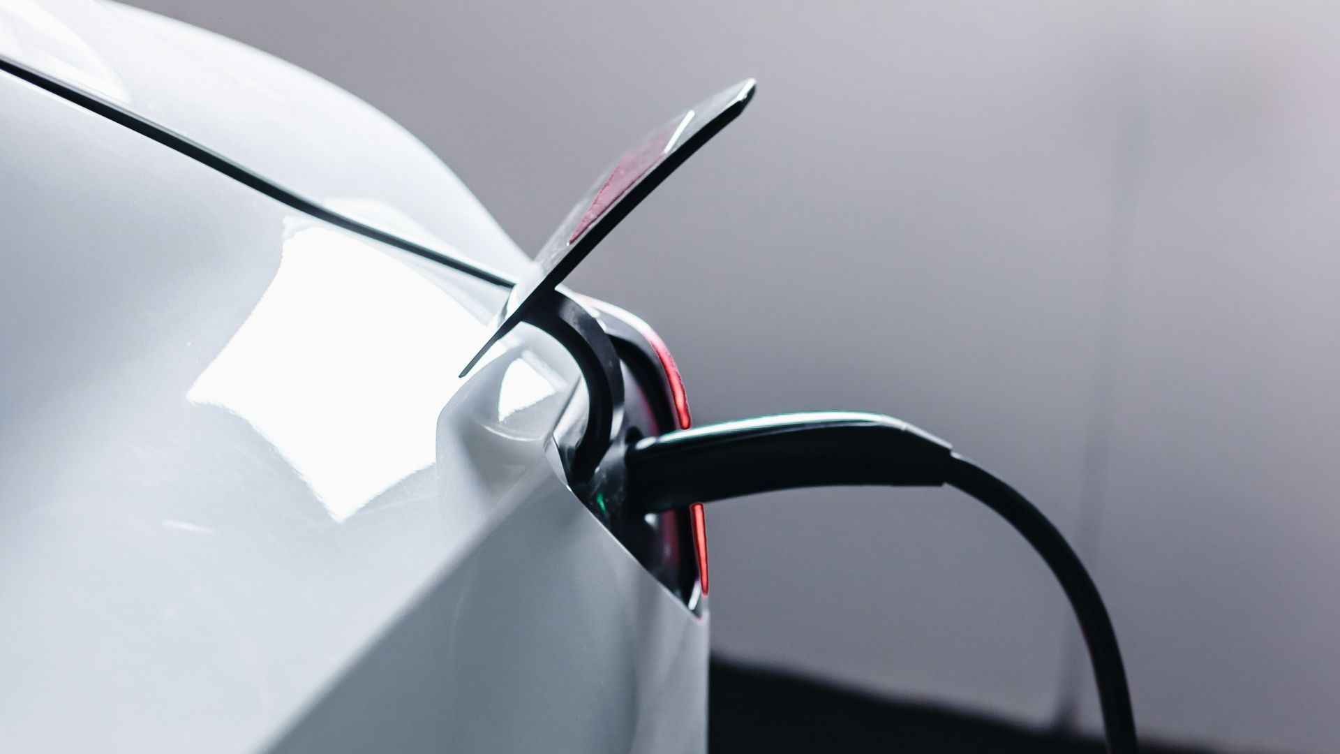 a white car is plugged in to a charger