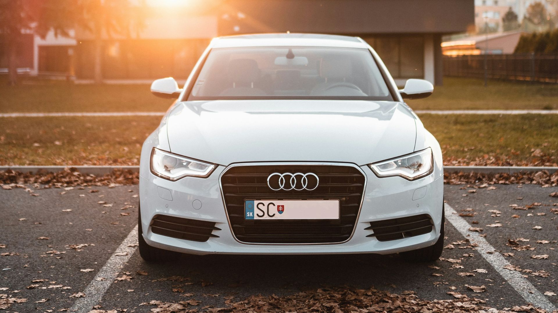 white Audi sedan on parked