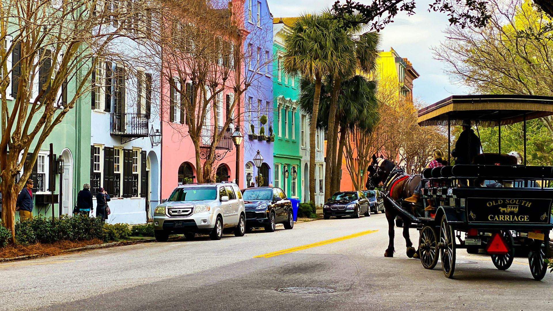 people riding on carriage on road during daytime
