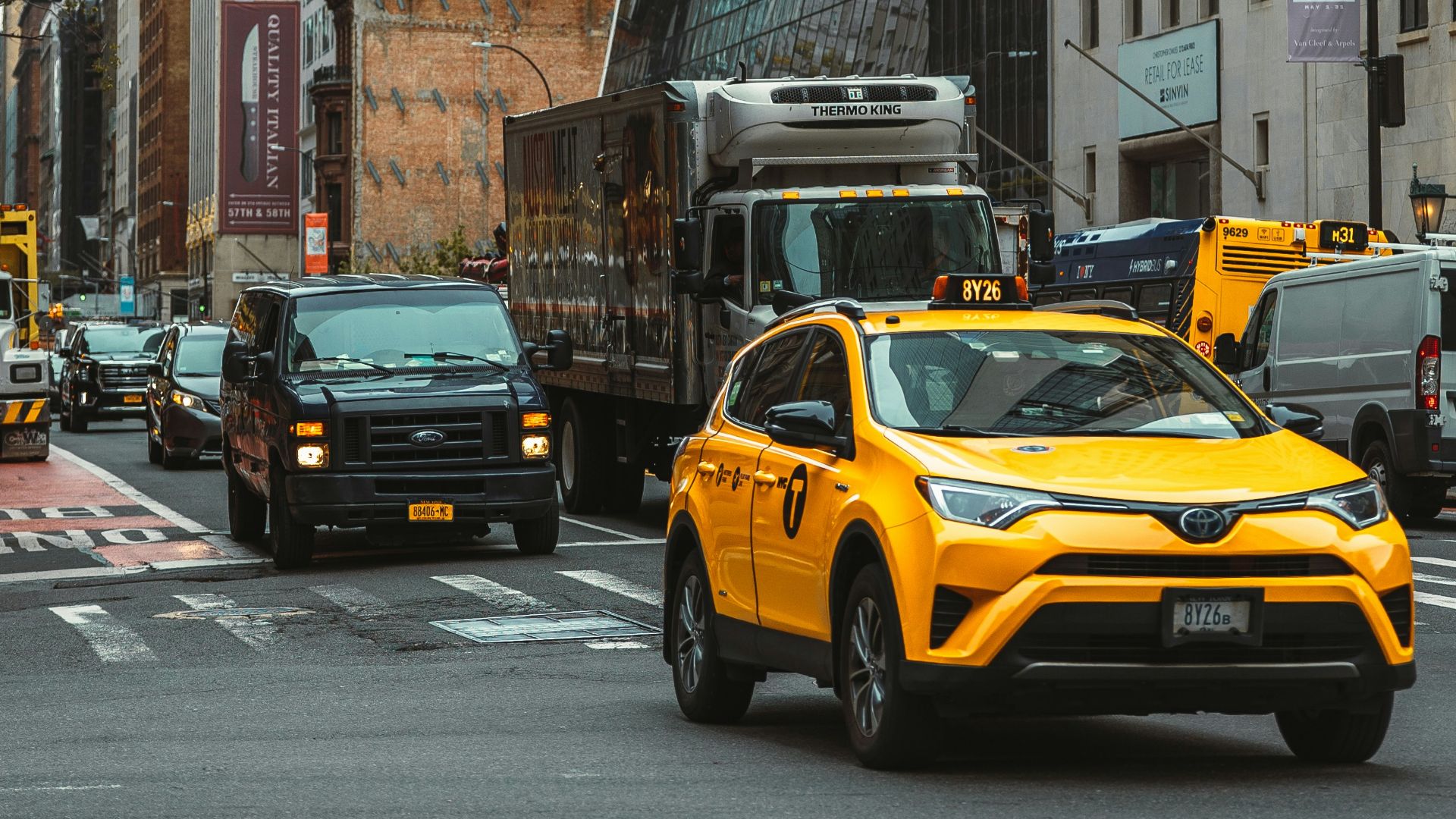 a yellow taxi on a busy street