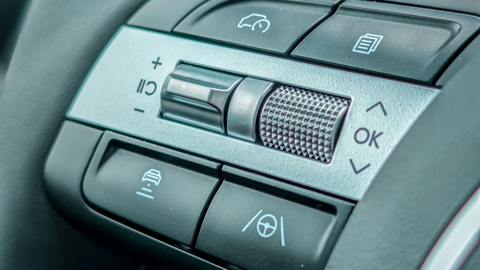 Close-up of a modern car steering wheel controls.