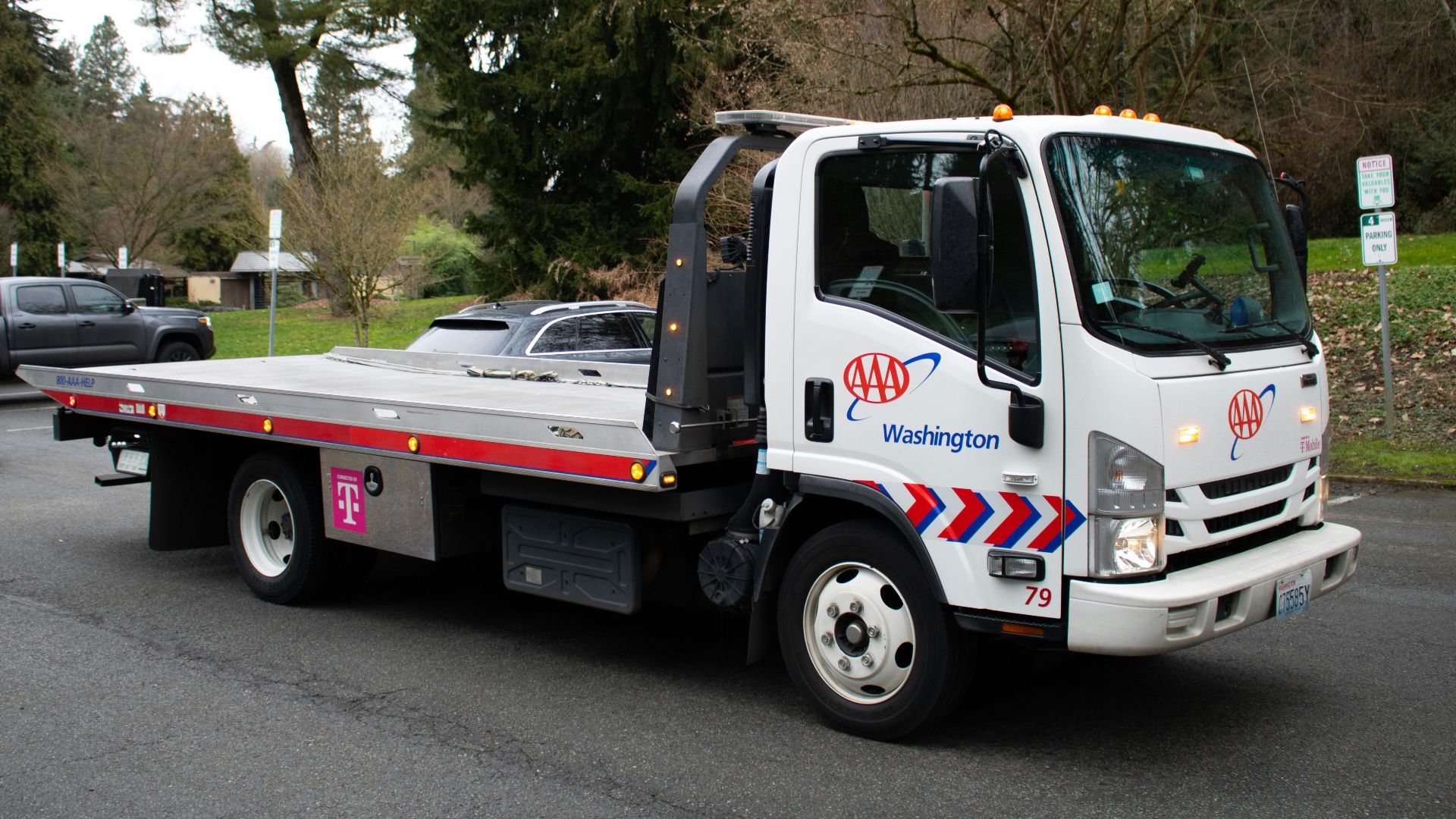 A tow truck is driving on a street.