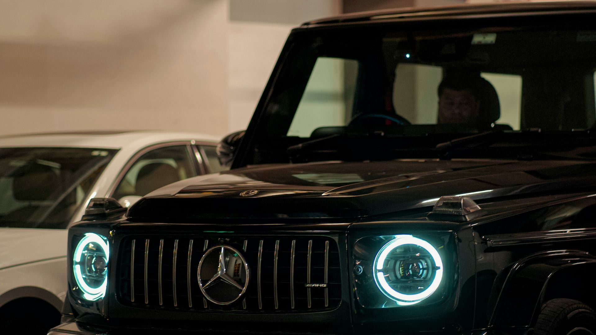 A black mercedes-benz g-wagon is parked.