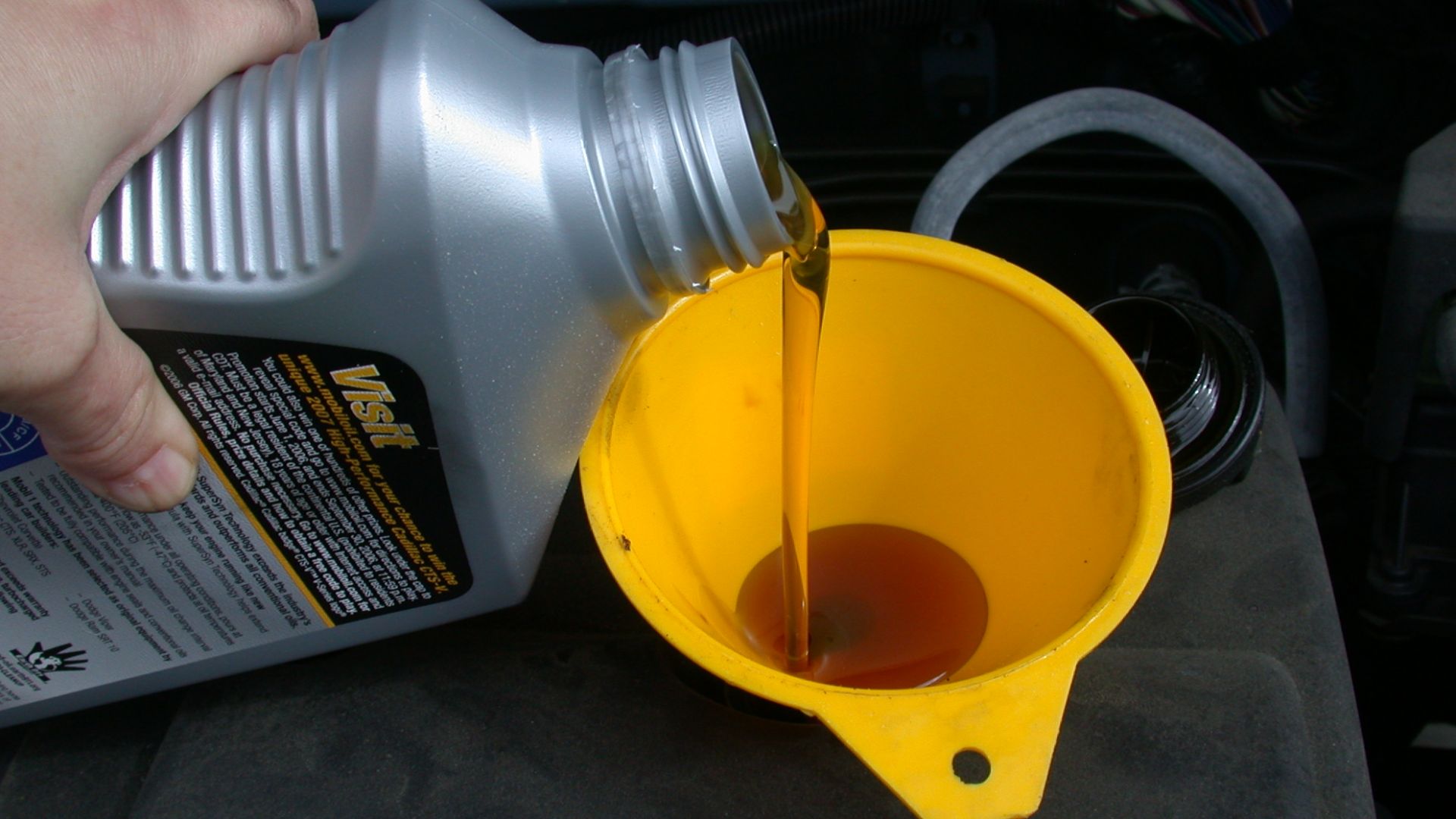 File:Motor oil refill with funnel.JPG