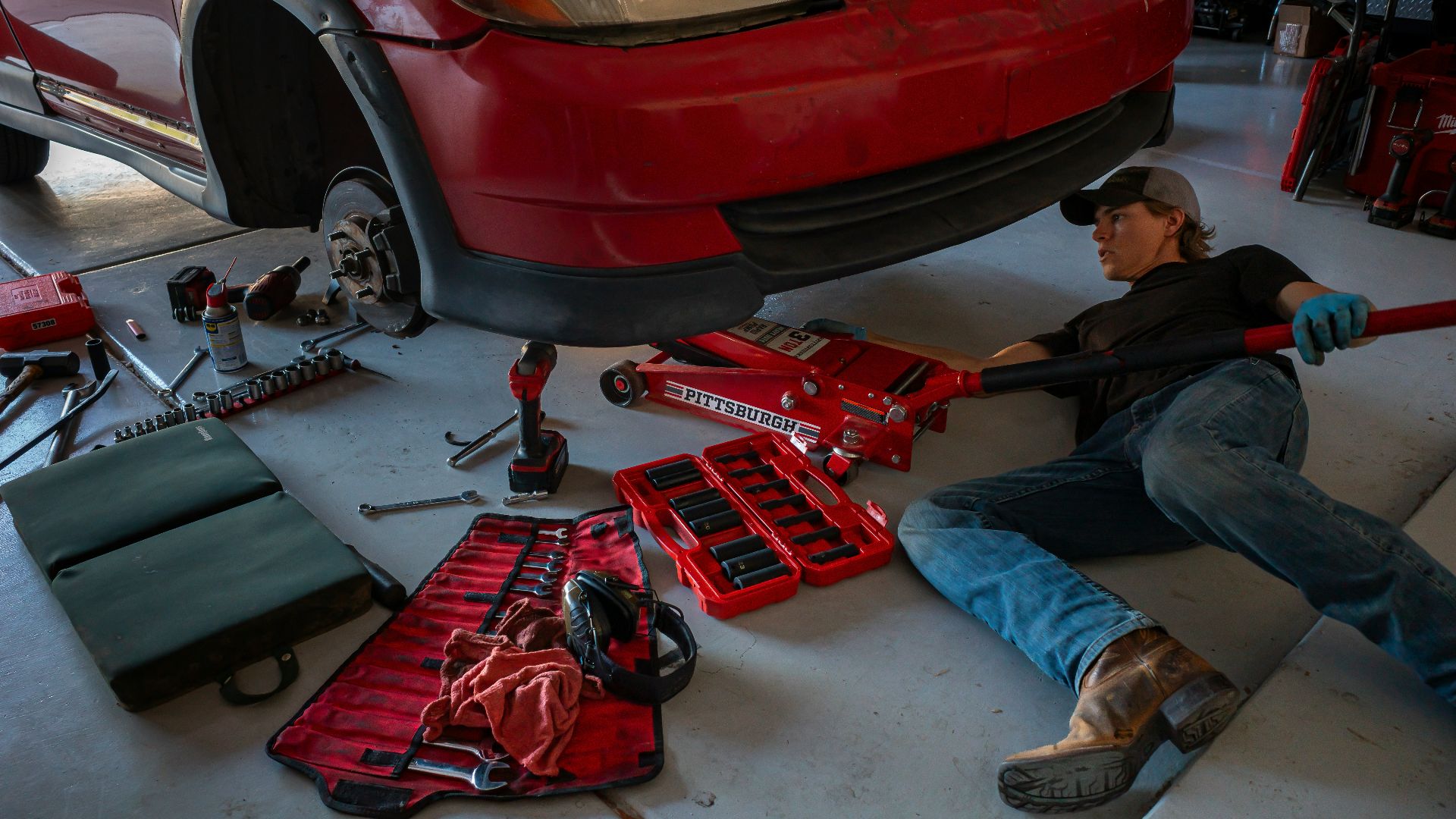 a man working on a car in a garage