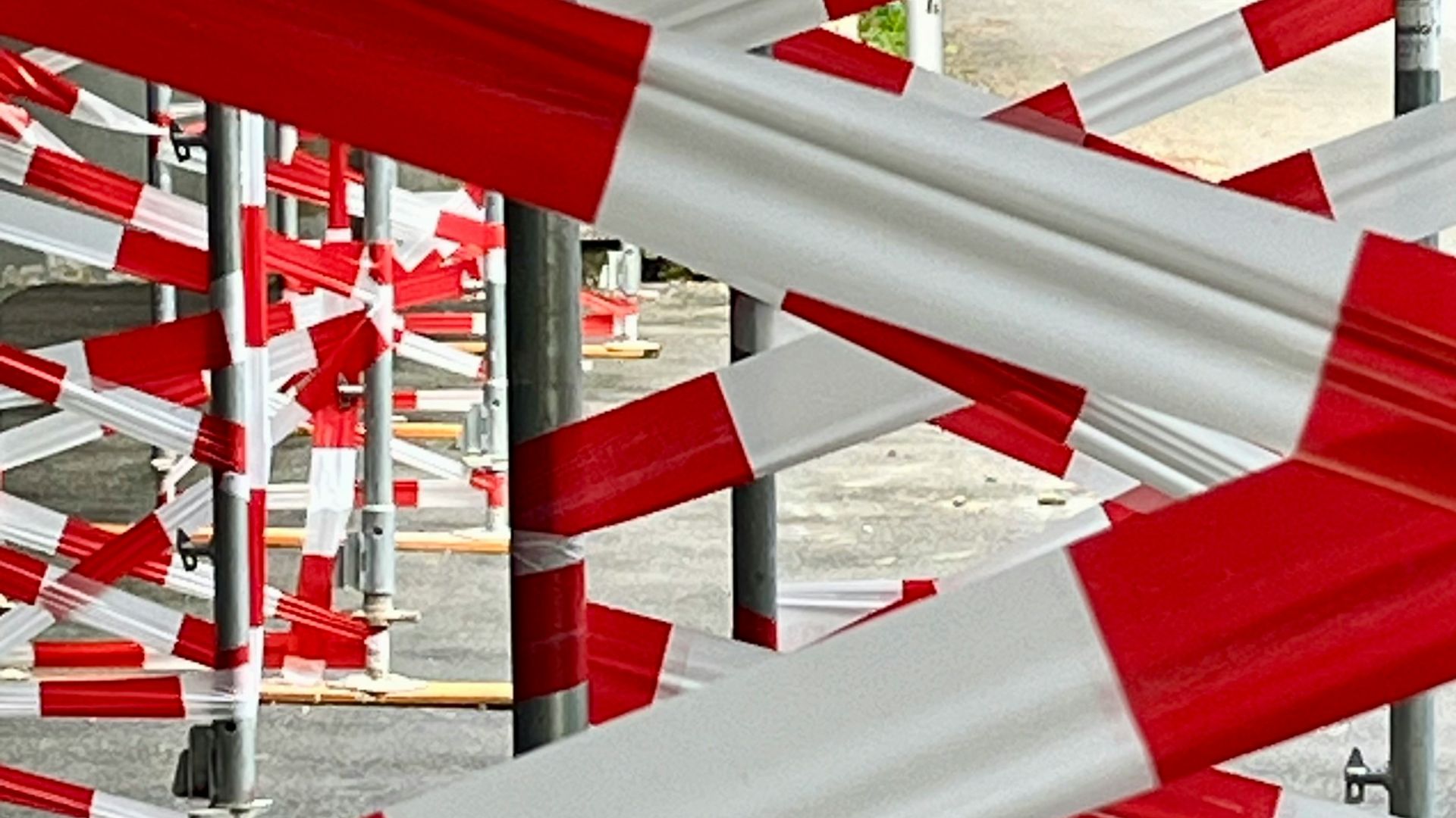 A bunch of red and white barriers in a parking lot