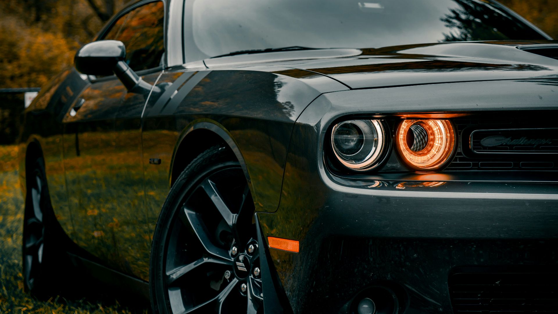 black porsche 911 parked on dirt road during daytime