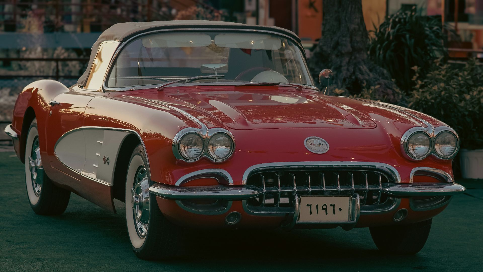 a red and white car parked in a parking lot