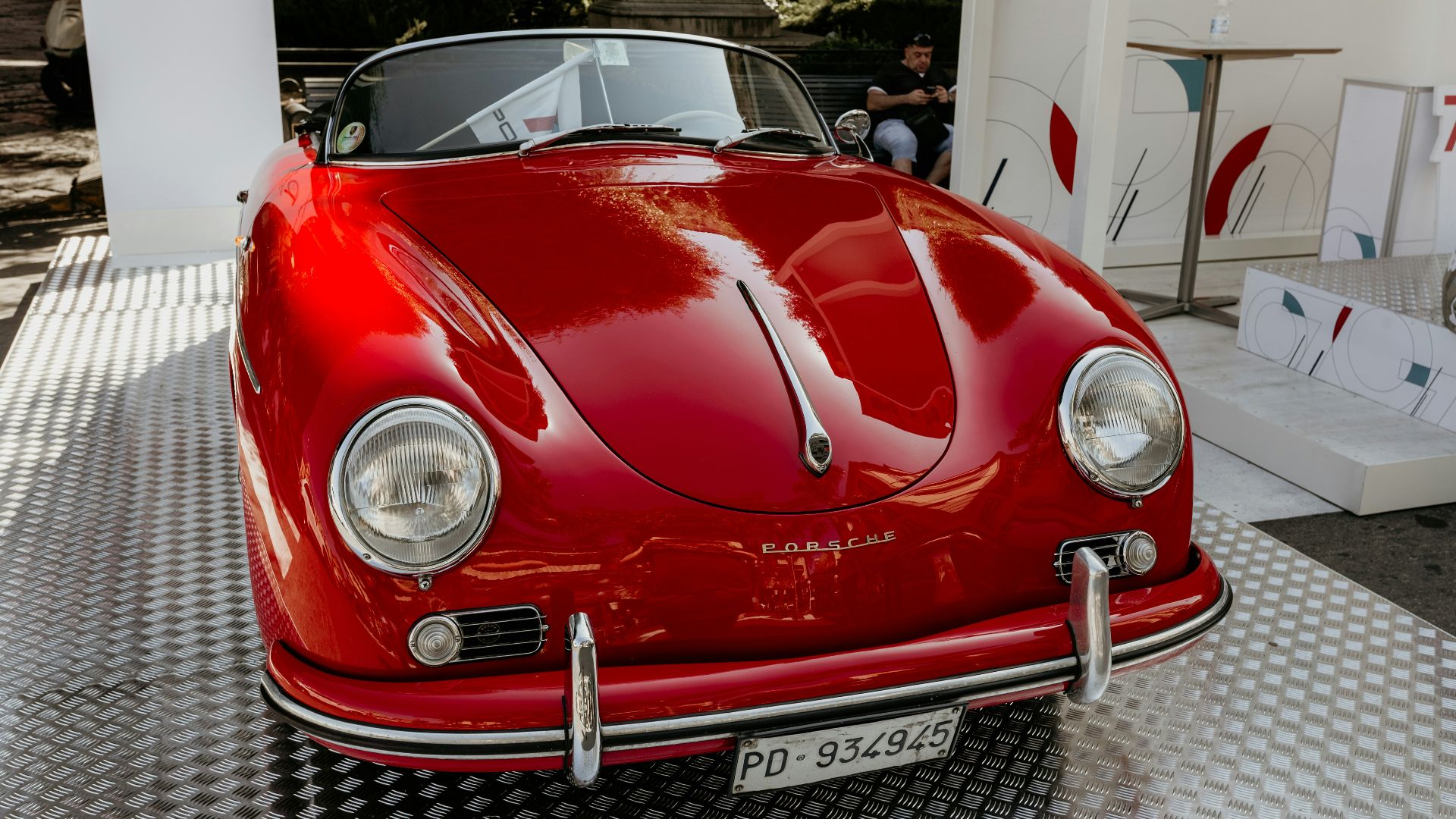 red porsche 911 parked in front of white building