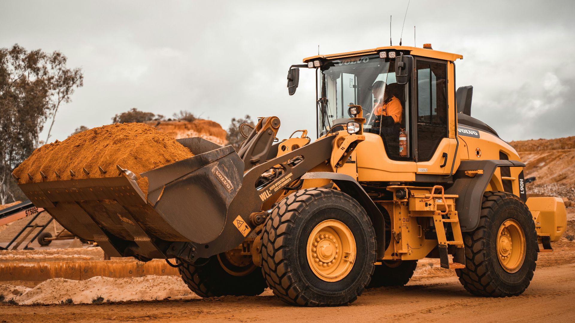 yellow and black heavy equipment on brown field during daytime
