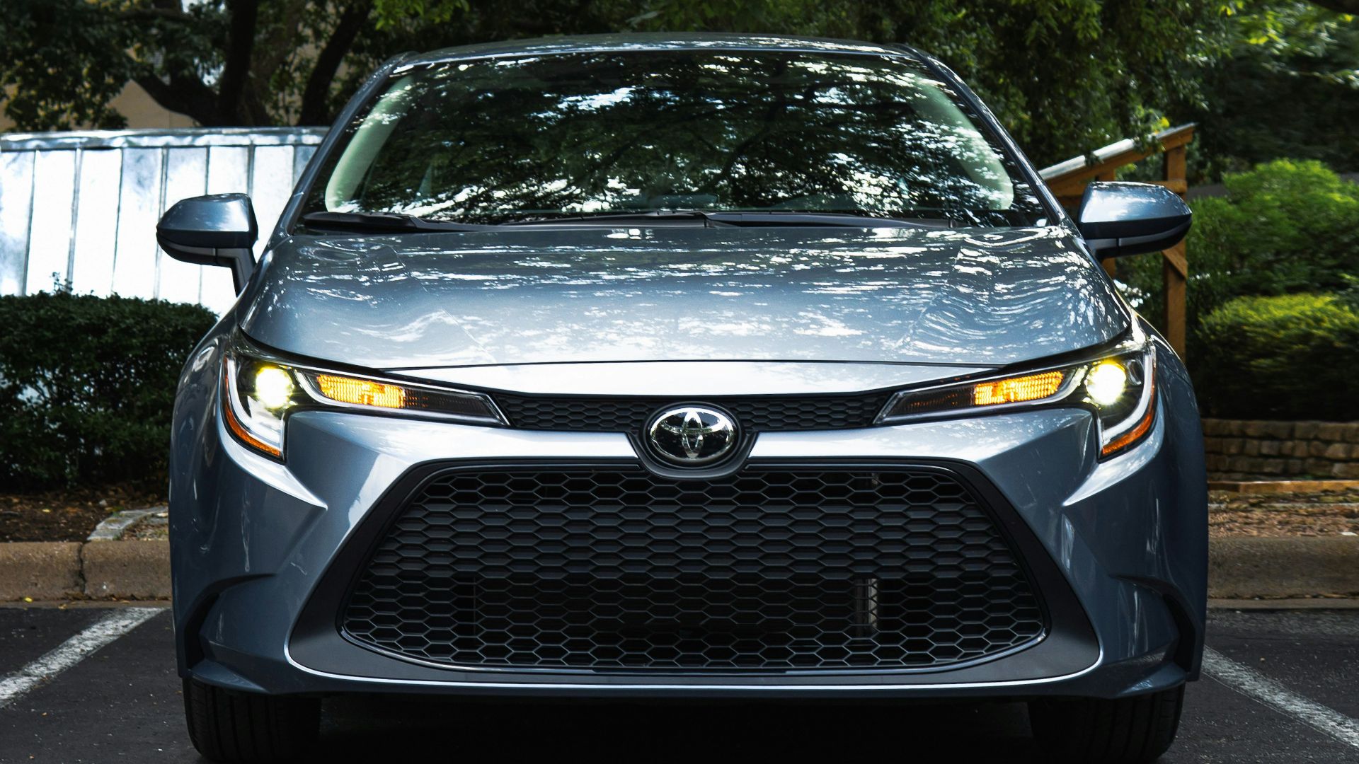 black mercedes benz car parked near green trees during daytime