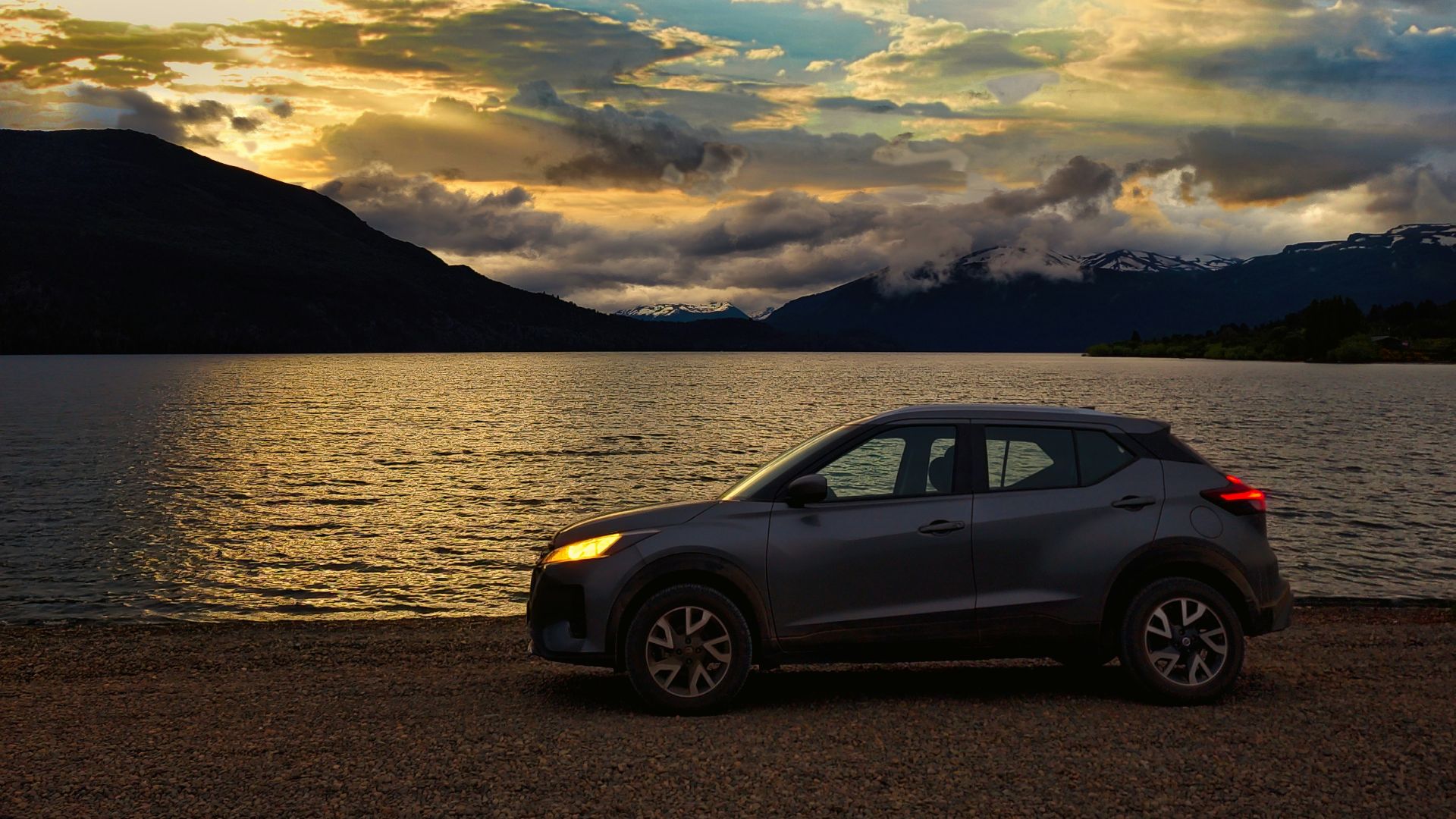 a car parked on the shore of a lake