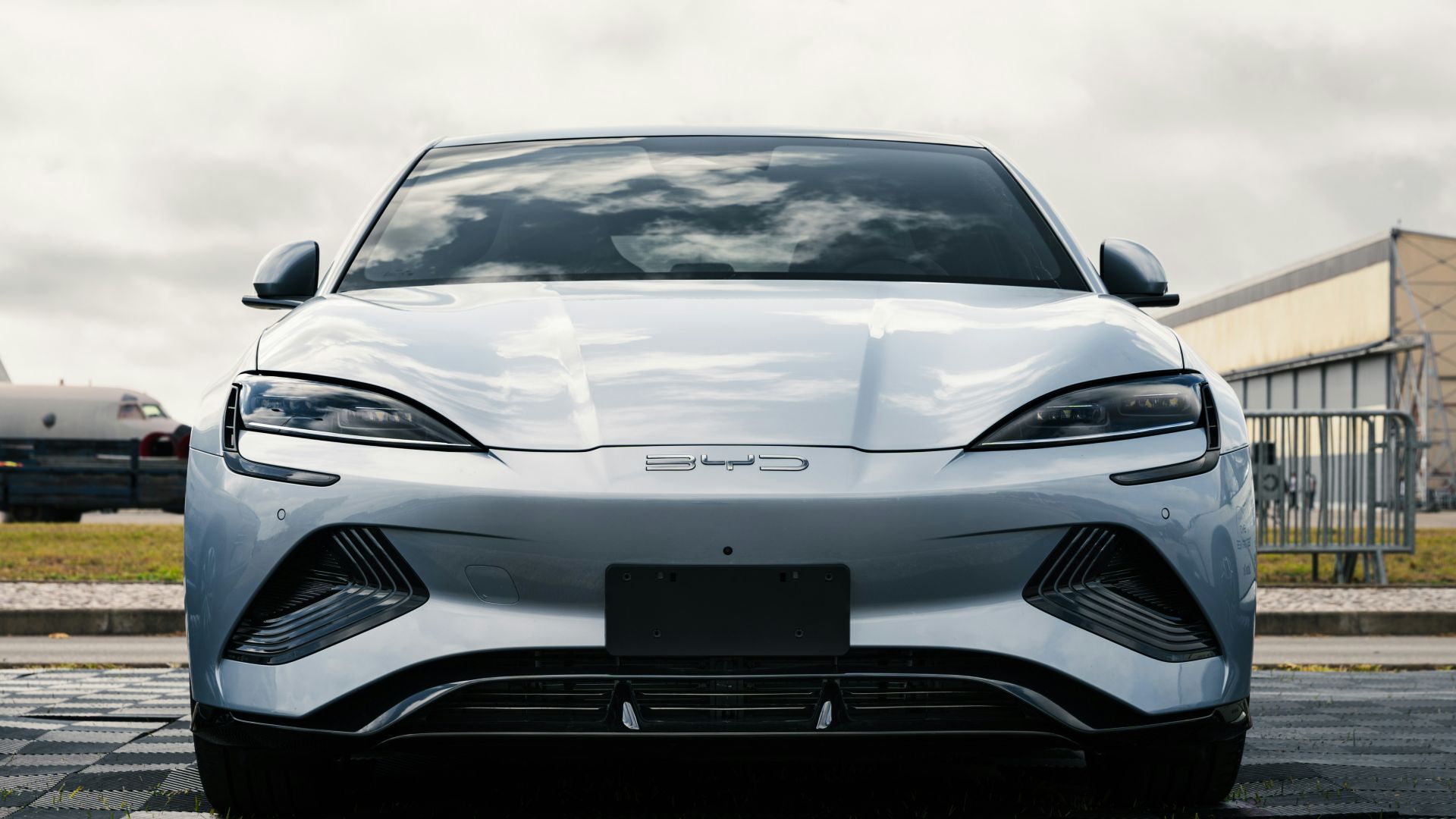 A white sports car parked on the side of the road