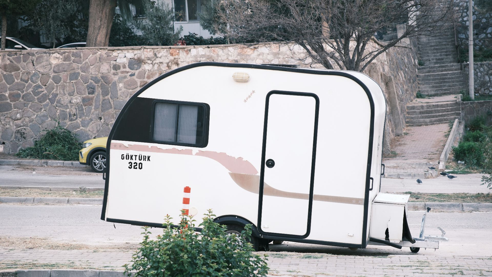 A white trailer parked on the side of a road