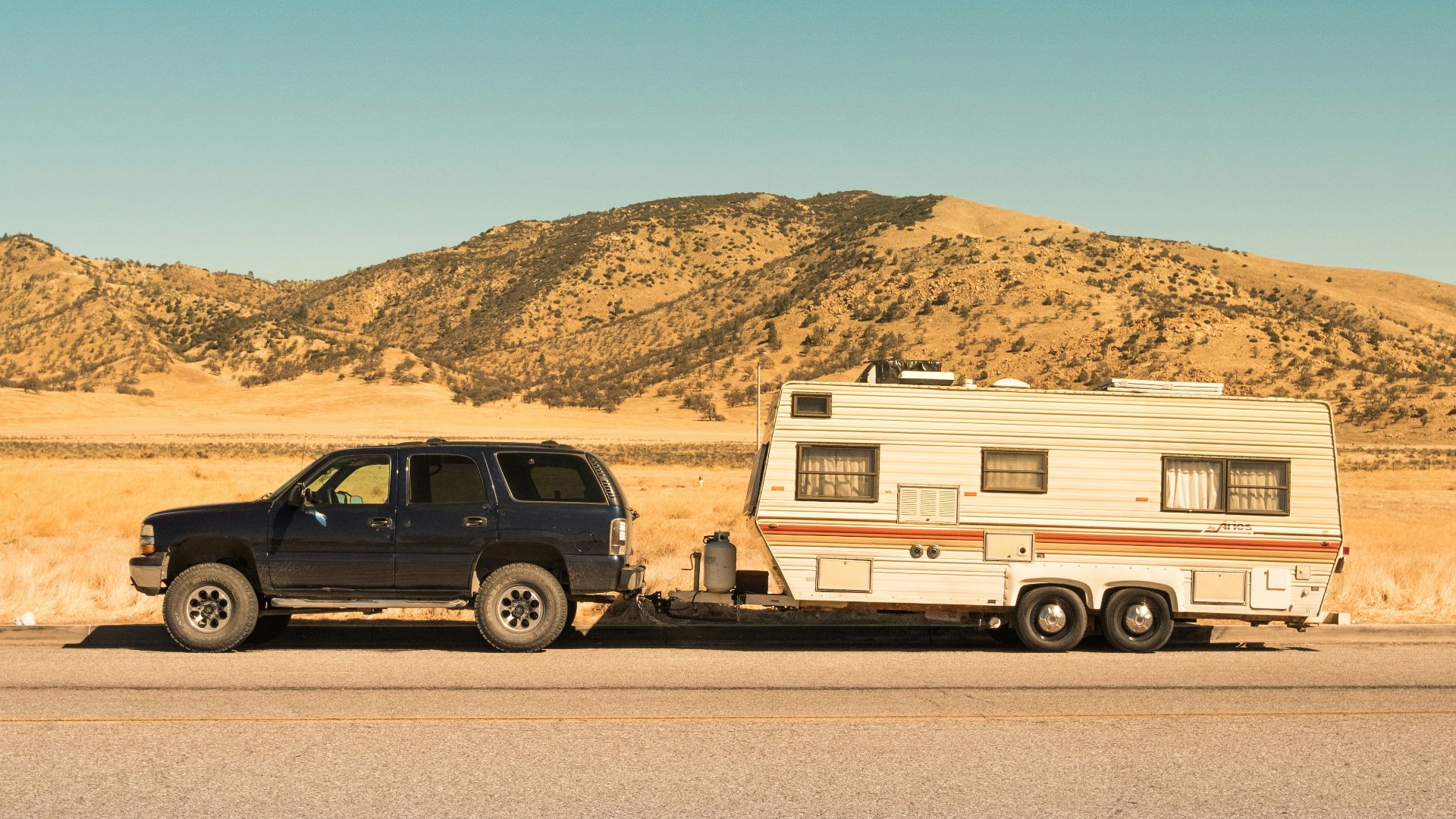 black SUV and white trailer