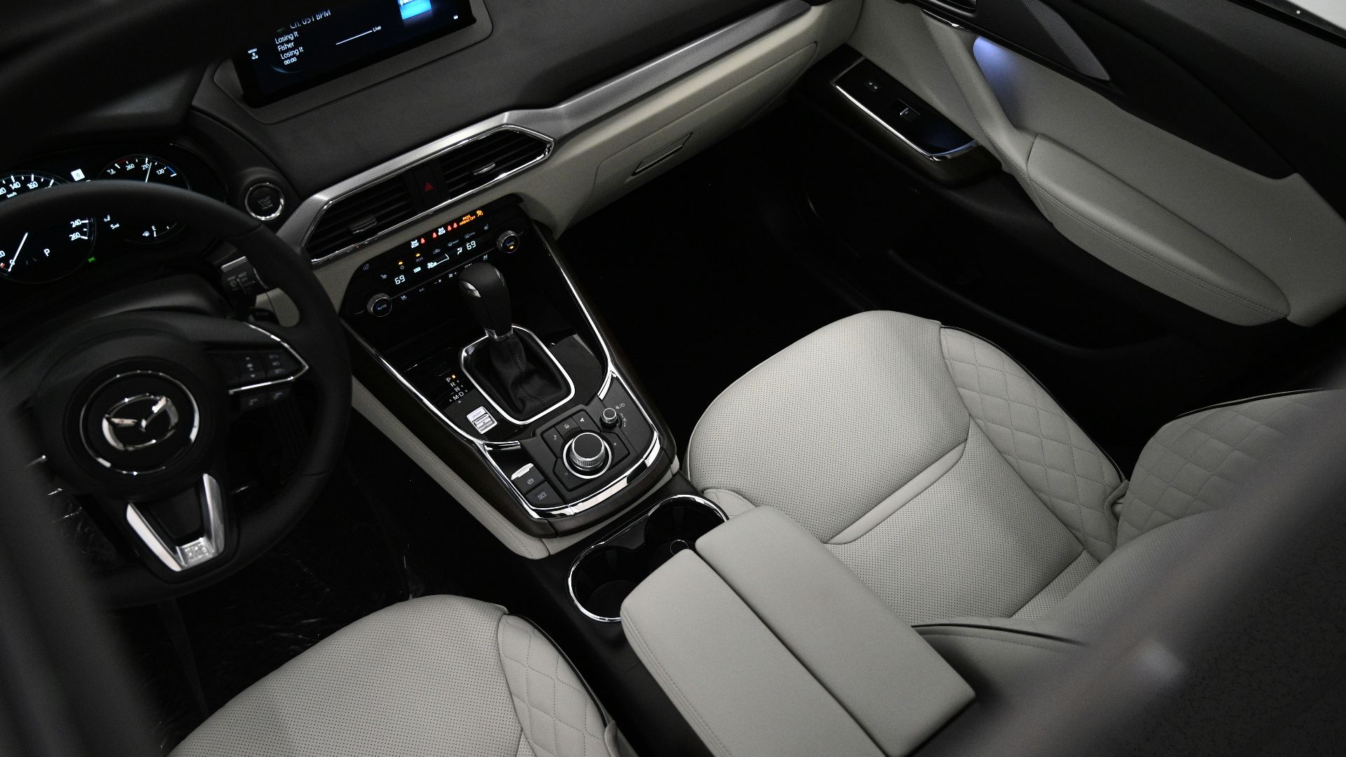 the interior of a car with a steering wheel and dashboard