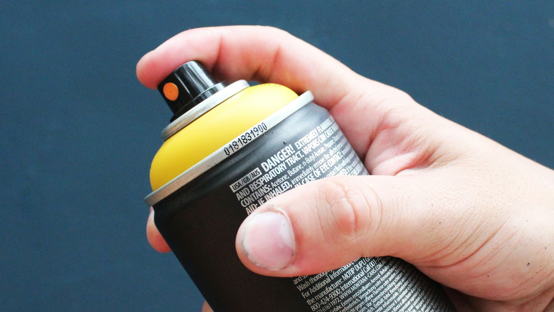 a person holding a black and yellow water bottle