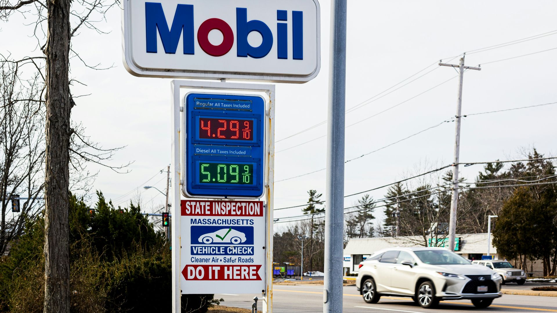 a mobil gas station sign next to a road