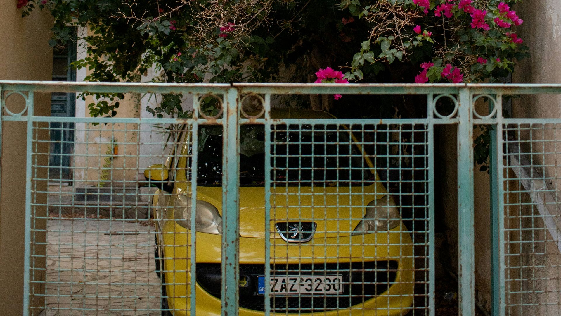 A yellow car parked in front of a building