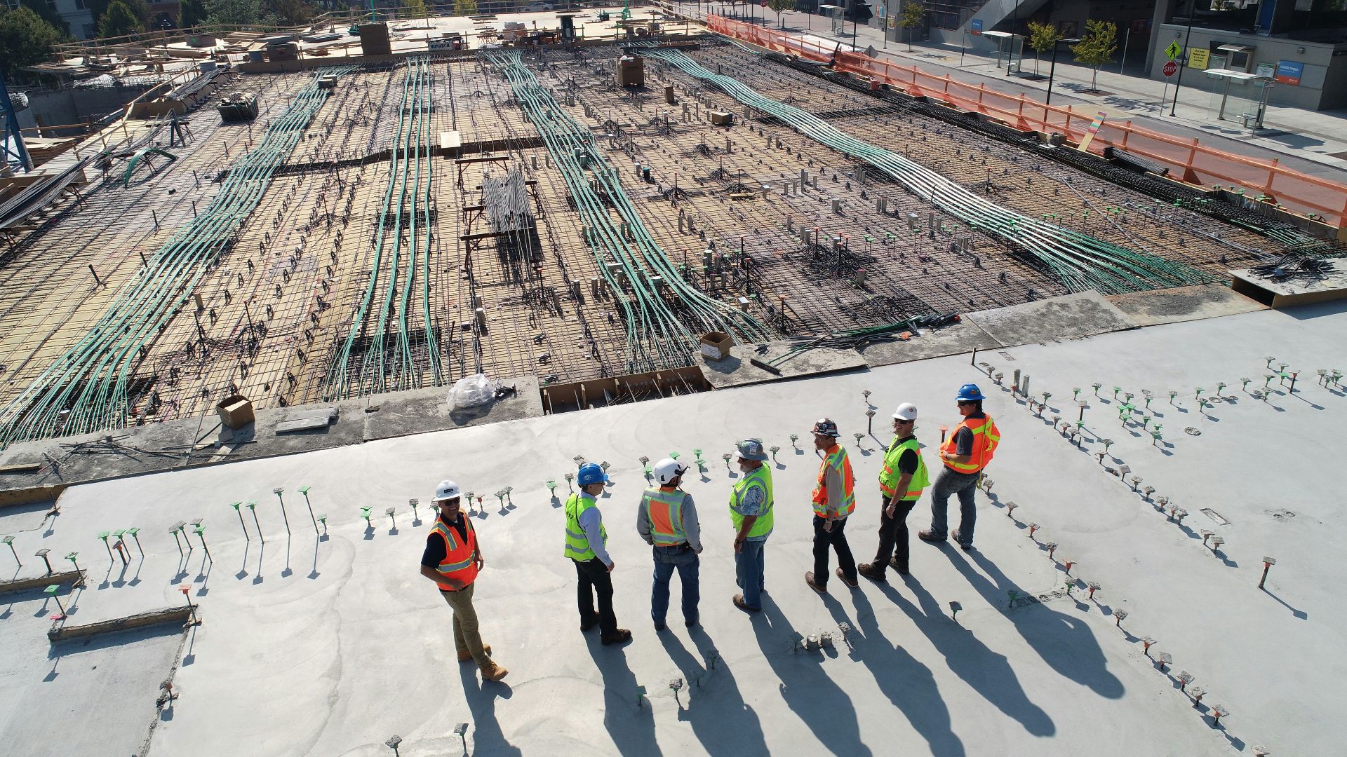 seven construction workers standing on white field