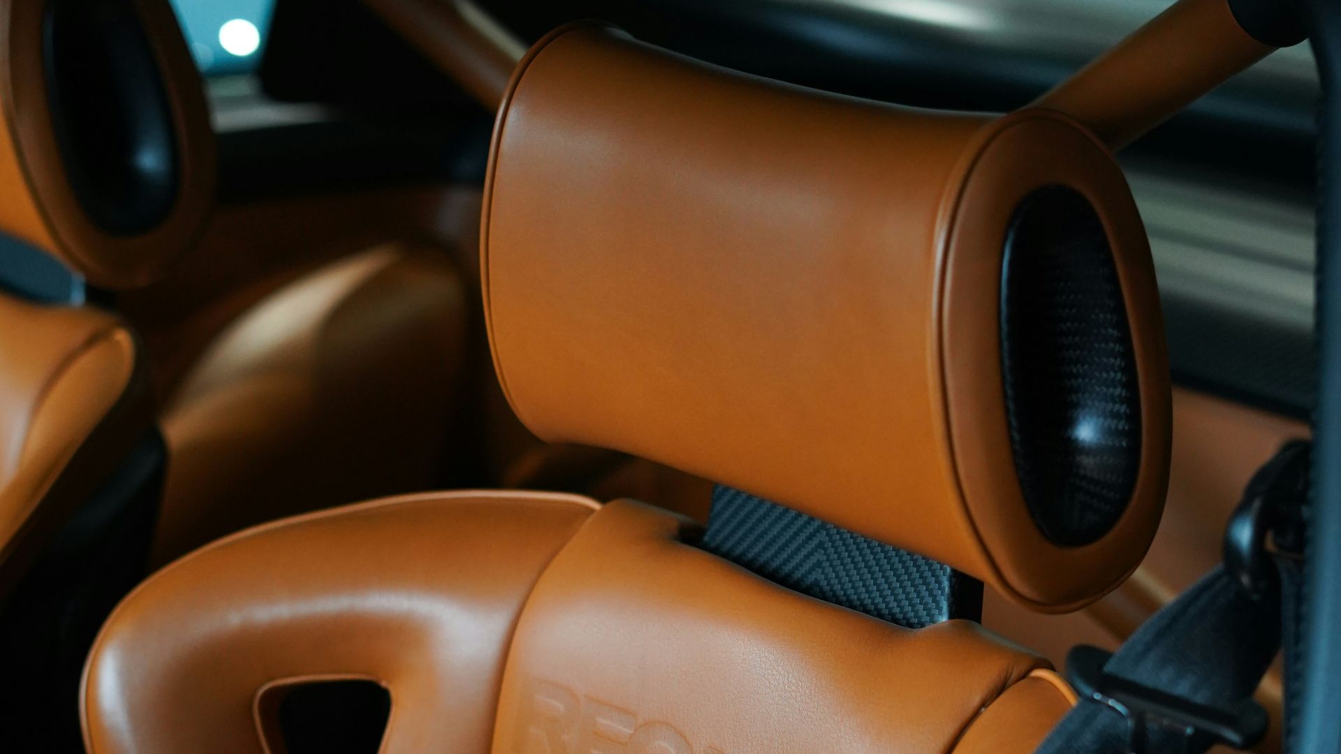 Brown leather recaro car seats with headrests.