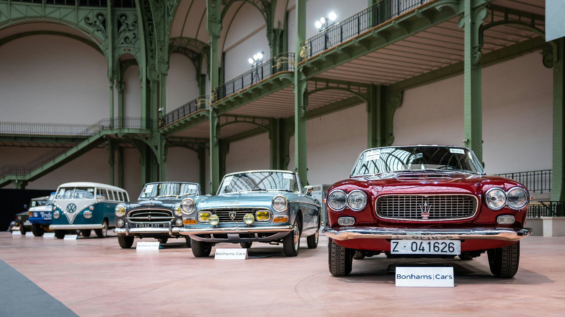 A row of old cars parked in a building