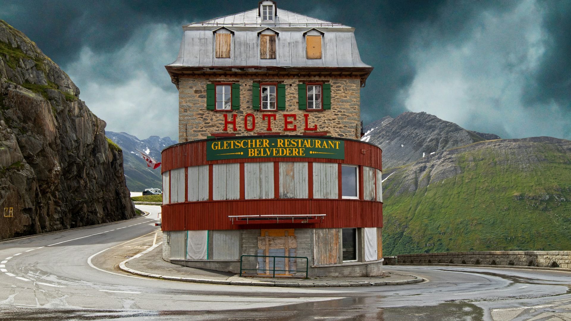 red and brown concrete building near mountain under white clouds during daytime