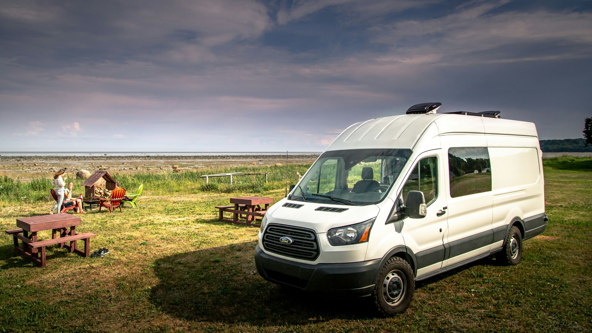white van on green grass field during daytime