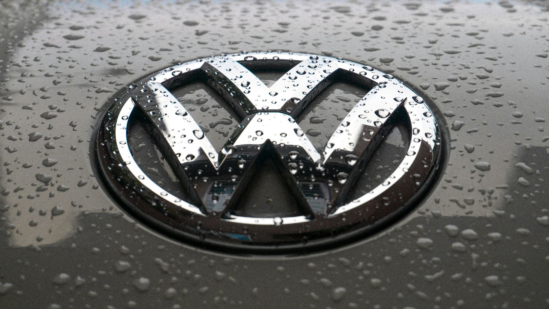 water dew on silver Volkswagen car emblem