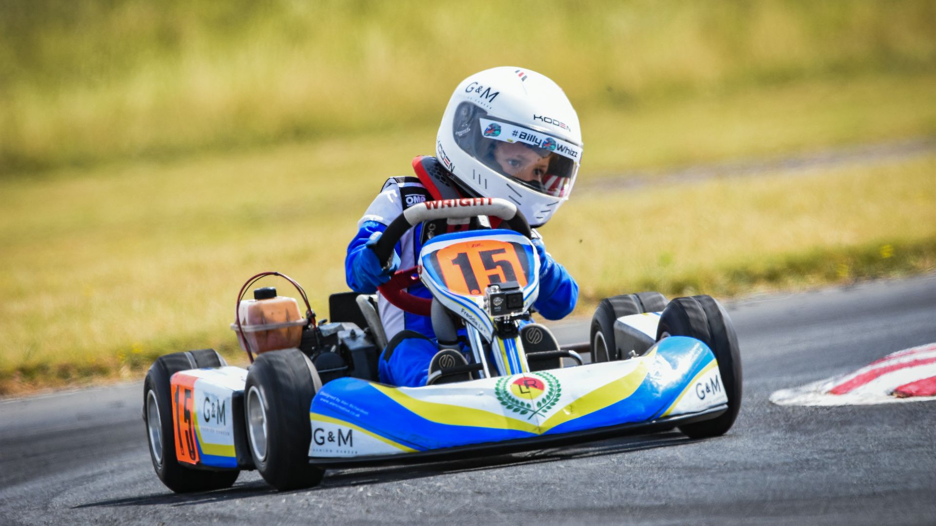 shallow focus photography of boy riding go-kart