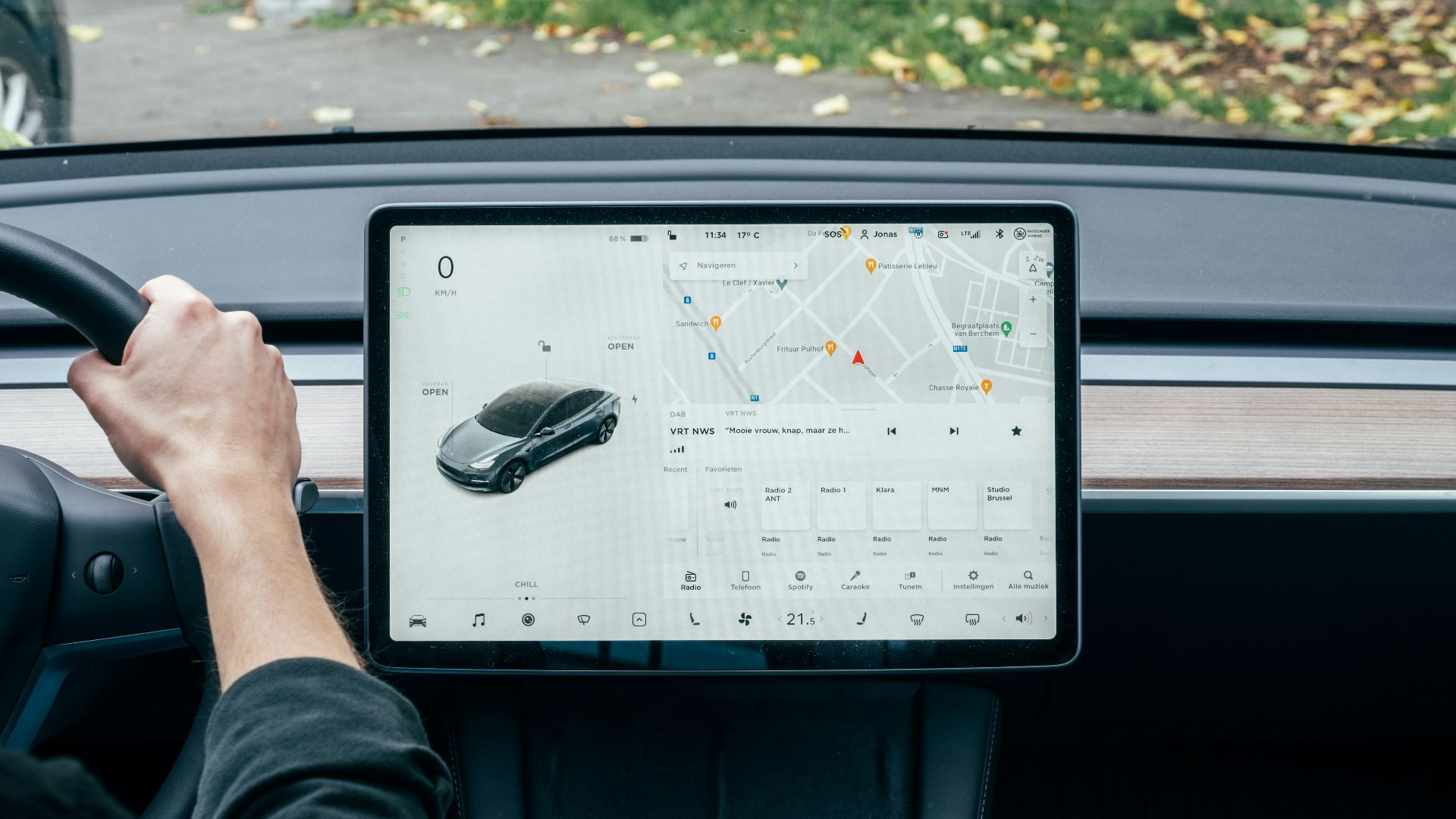a person driving a car with a computer on the dashboard