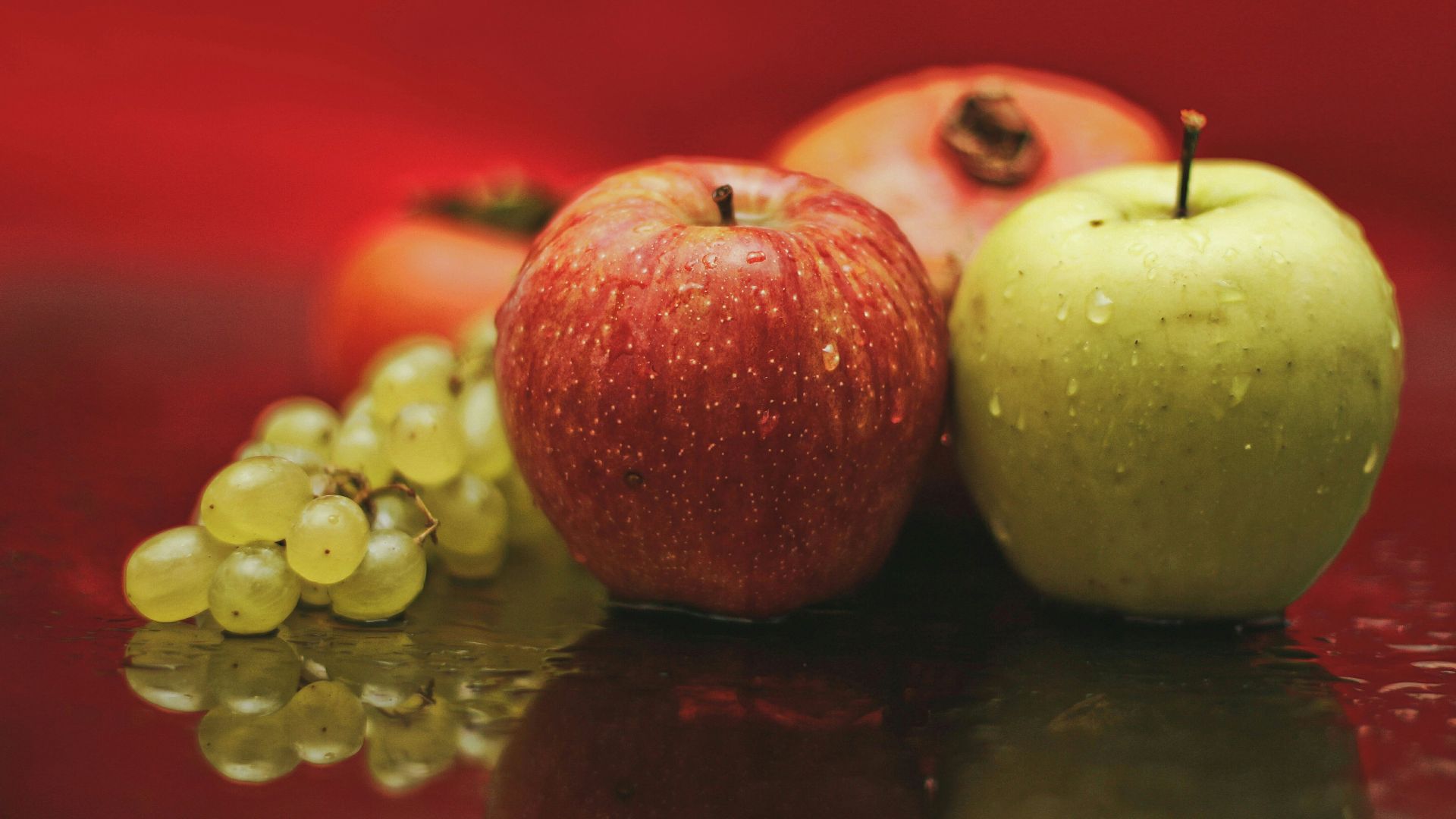 red apple fruit on black surface