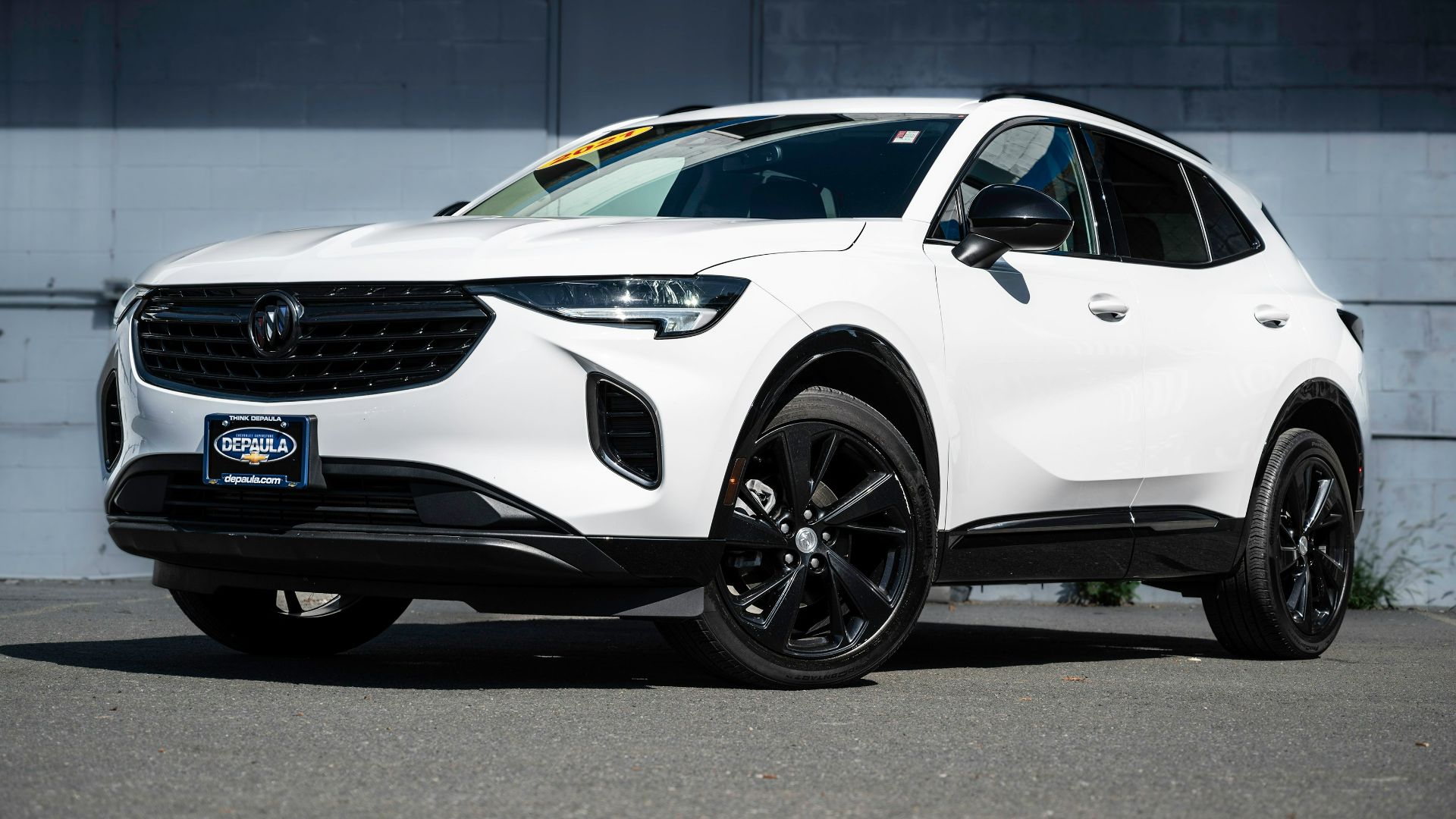 a white car parked in front of a building