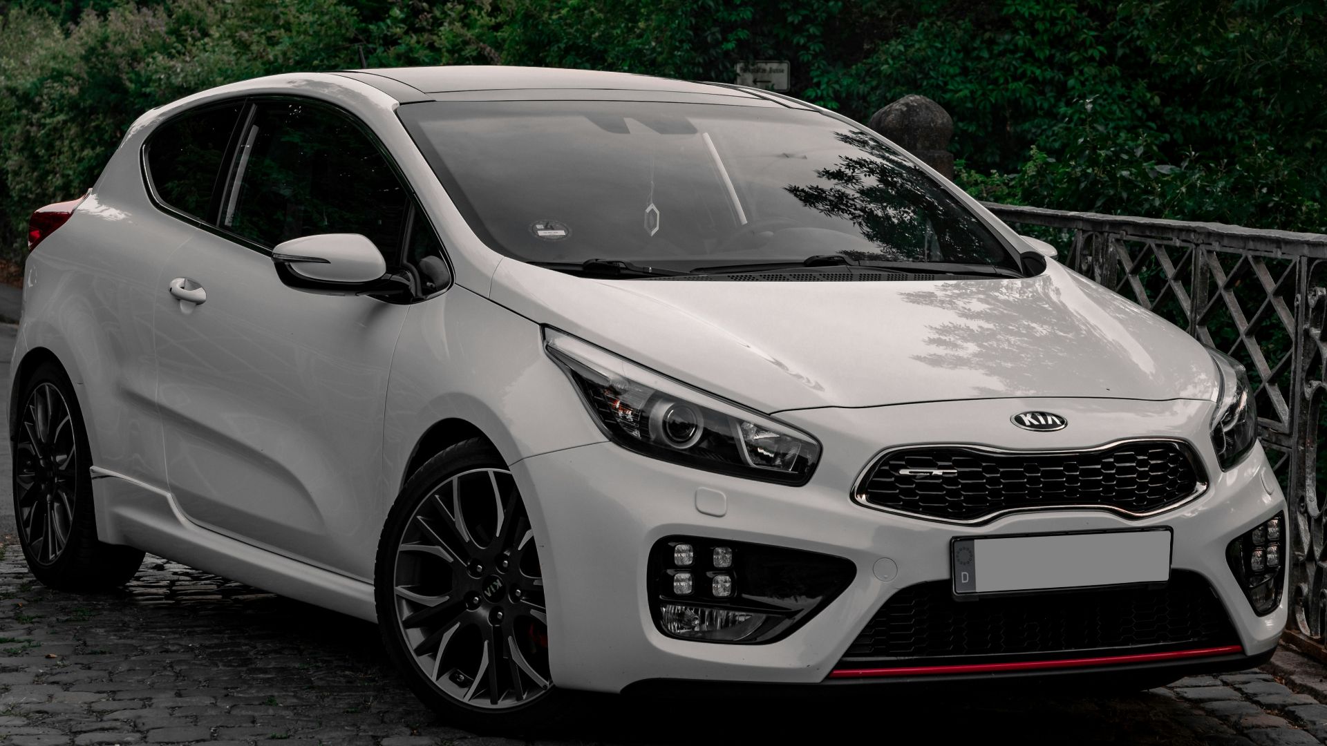 white bmw m 3 coupe parked on gray concrete pavement