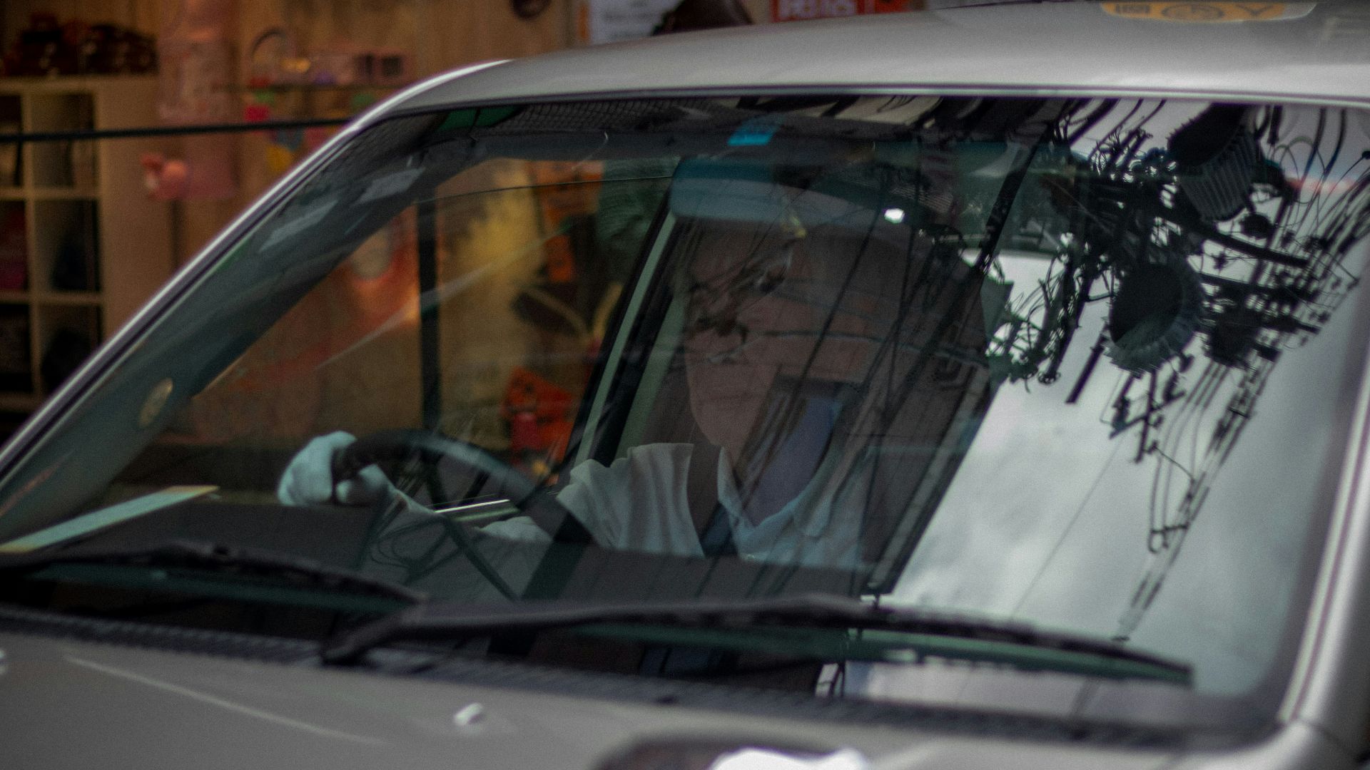 silver car with yellow sticker