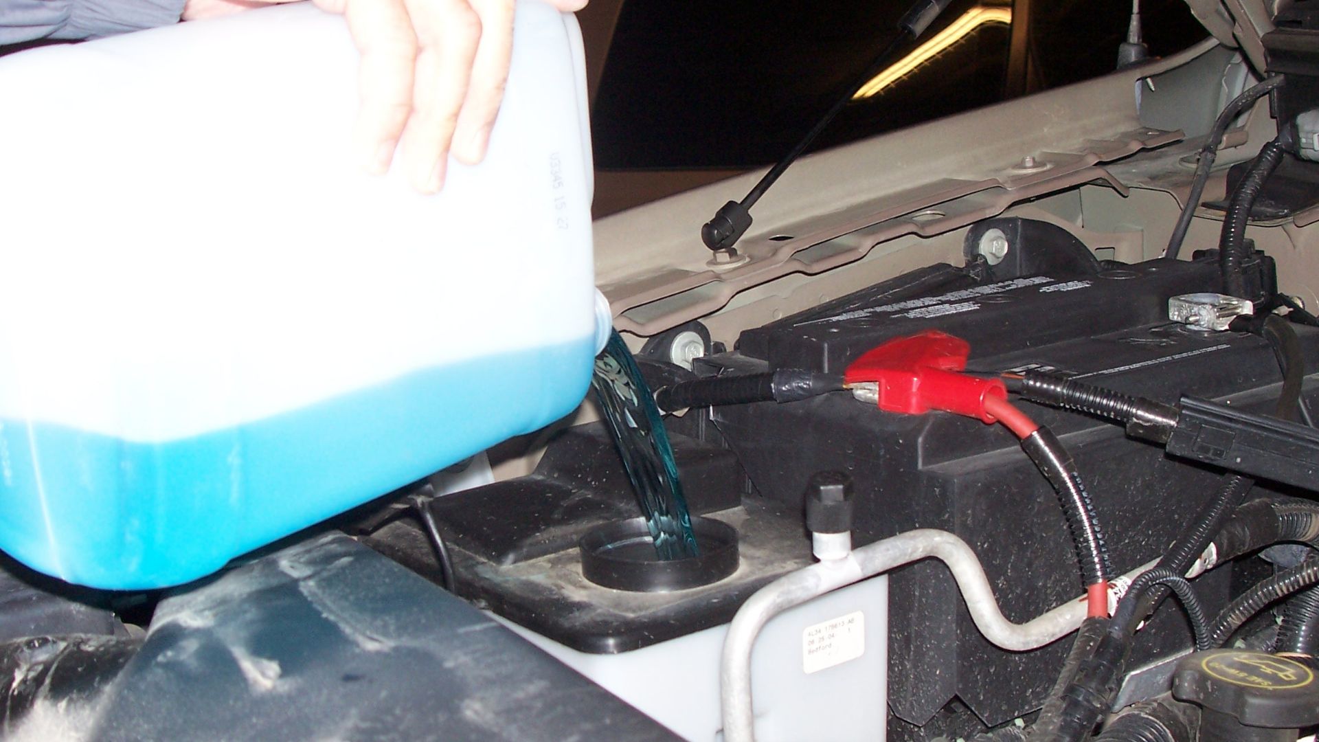 File:Man pouring windshield washer fluid.jpg