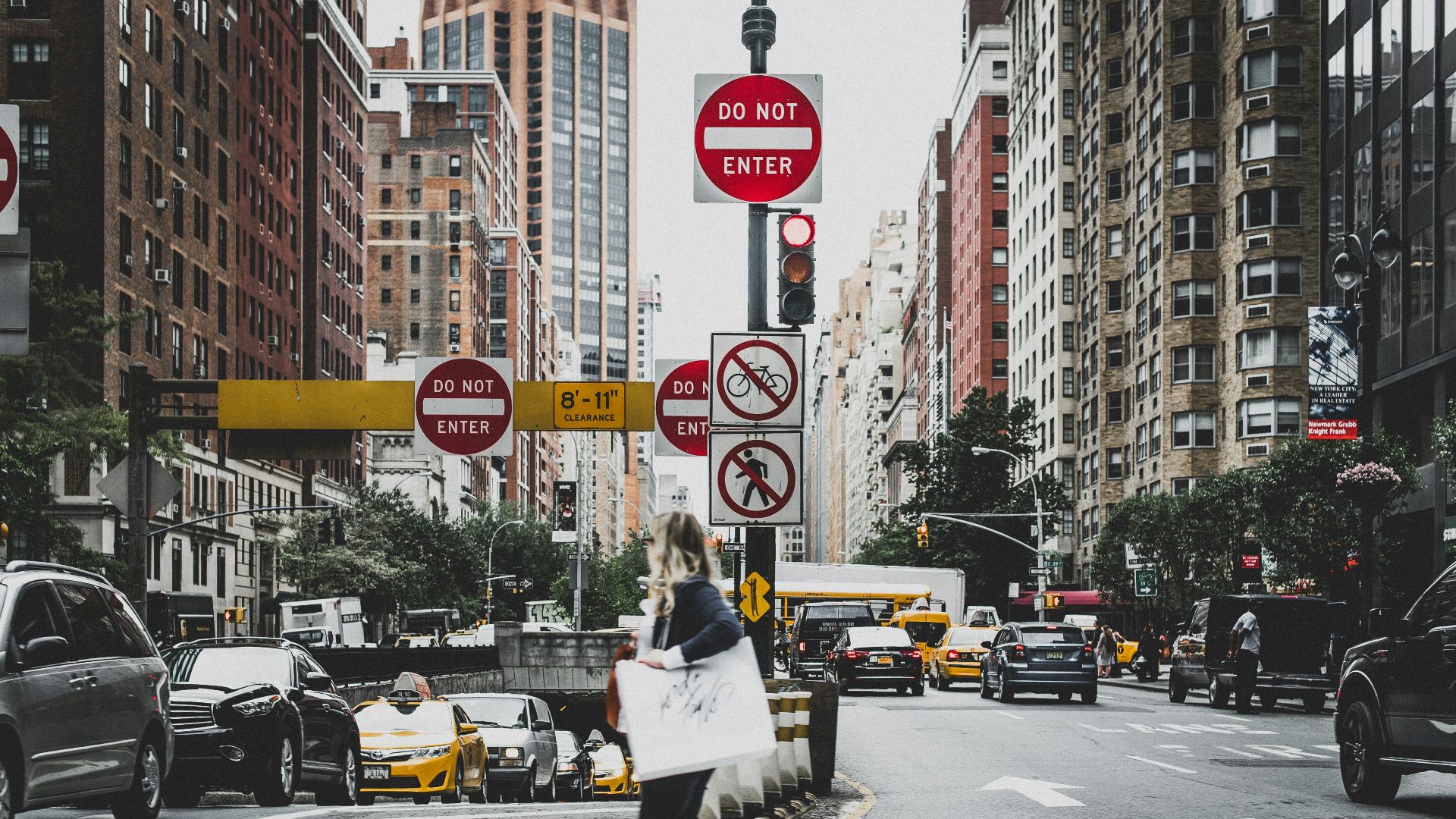 woman walking on road near cars