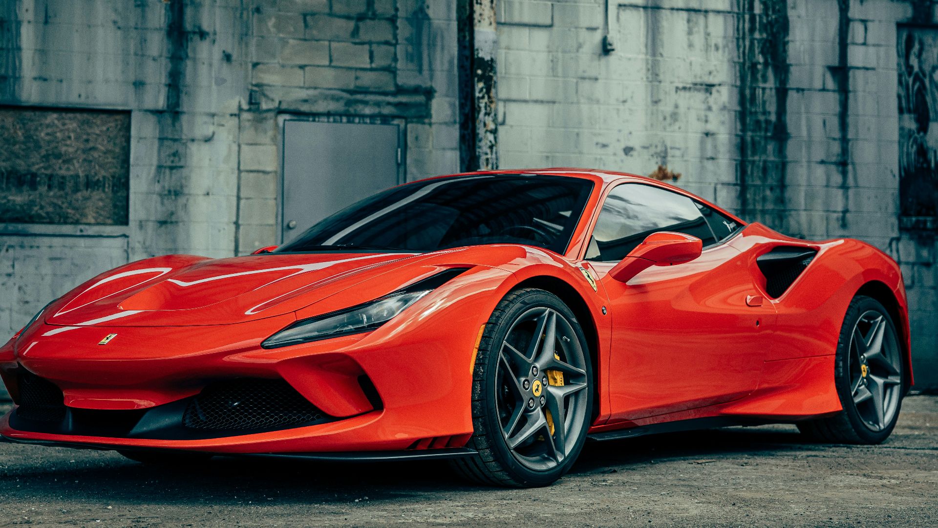 red ferrari 458 italia parked near gray building