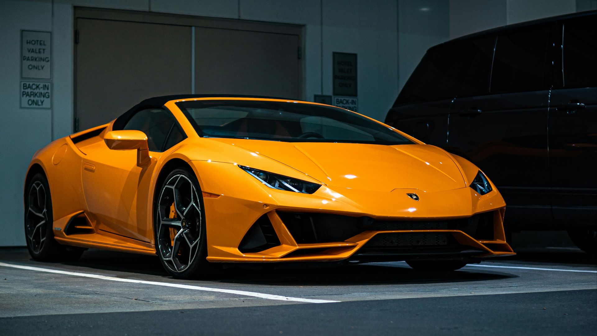 orange lamborghini aventador parked in garage