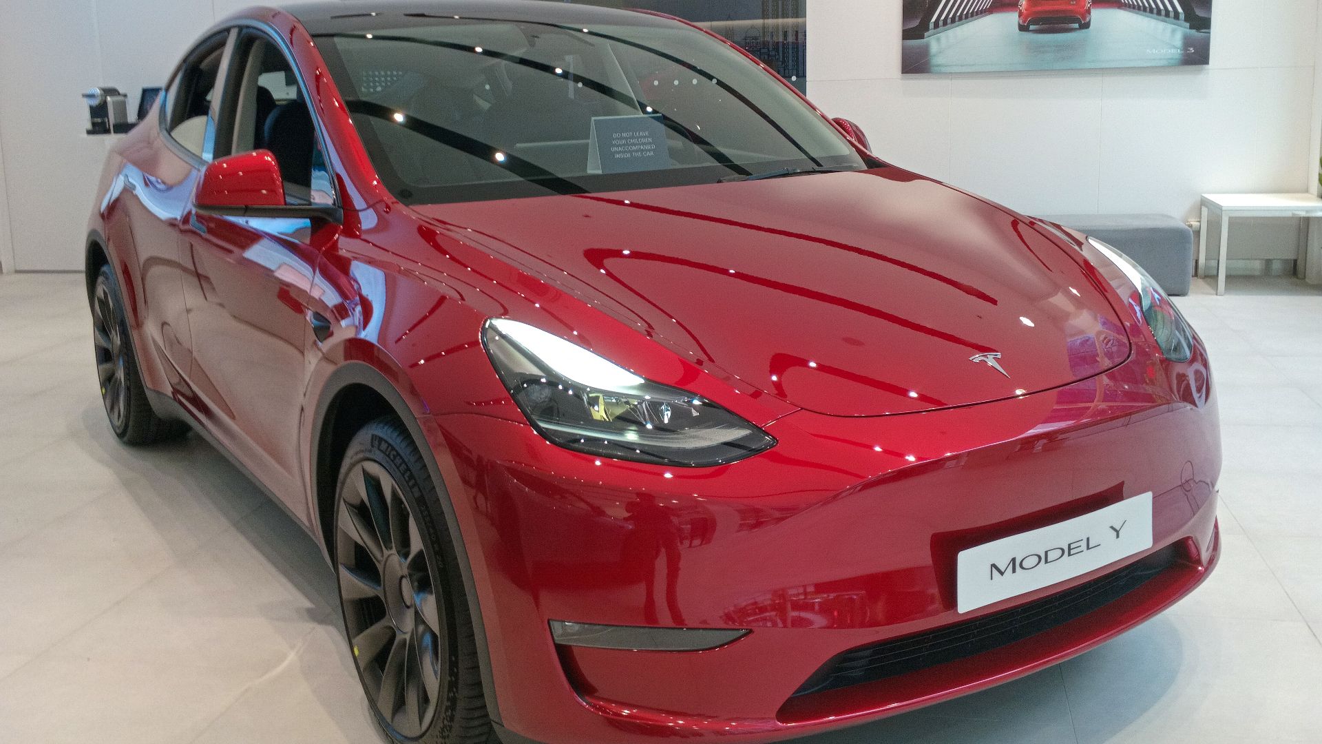 File:2025 Tesla Model Y Long Range AWD in Ultra Red, front right.jpg