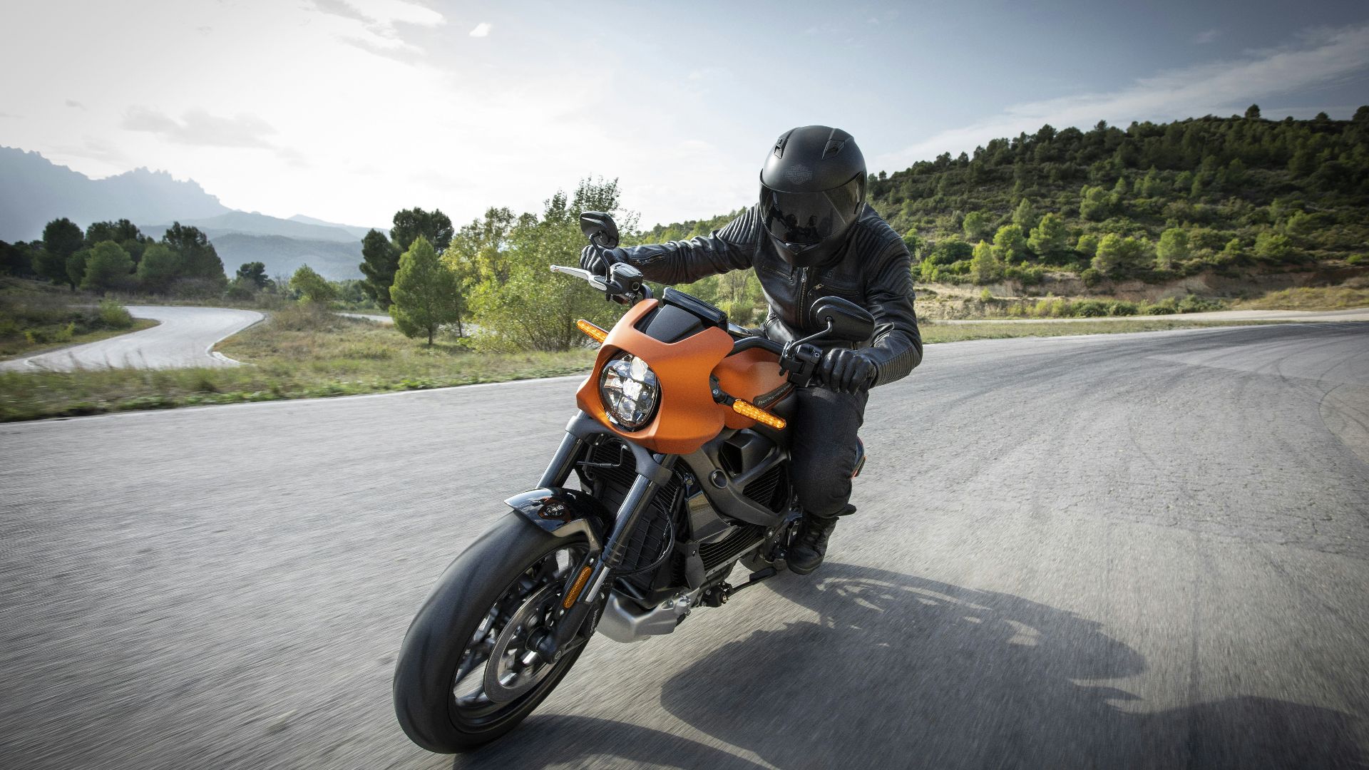 person driving orange motorcycle