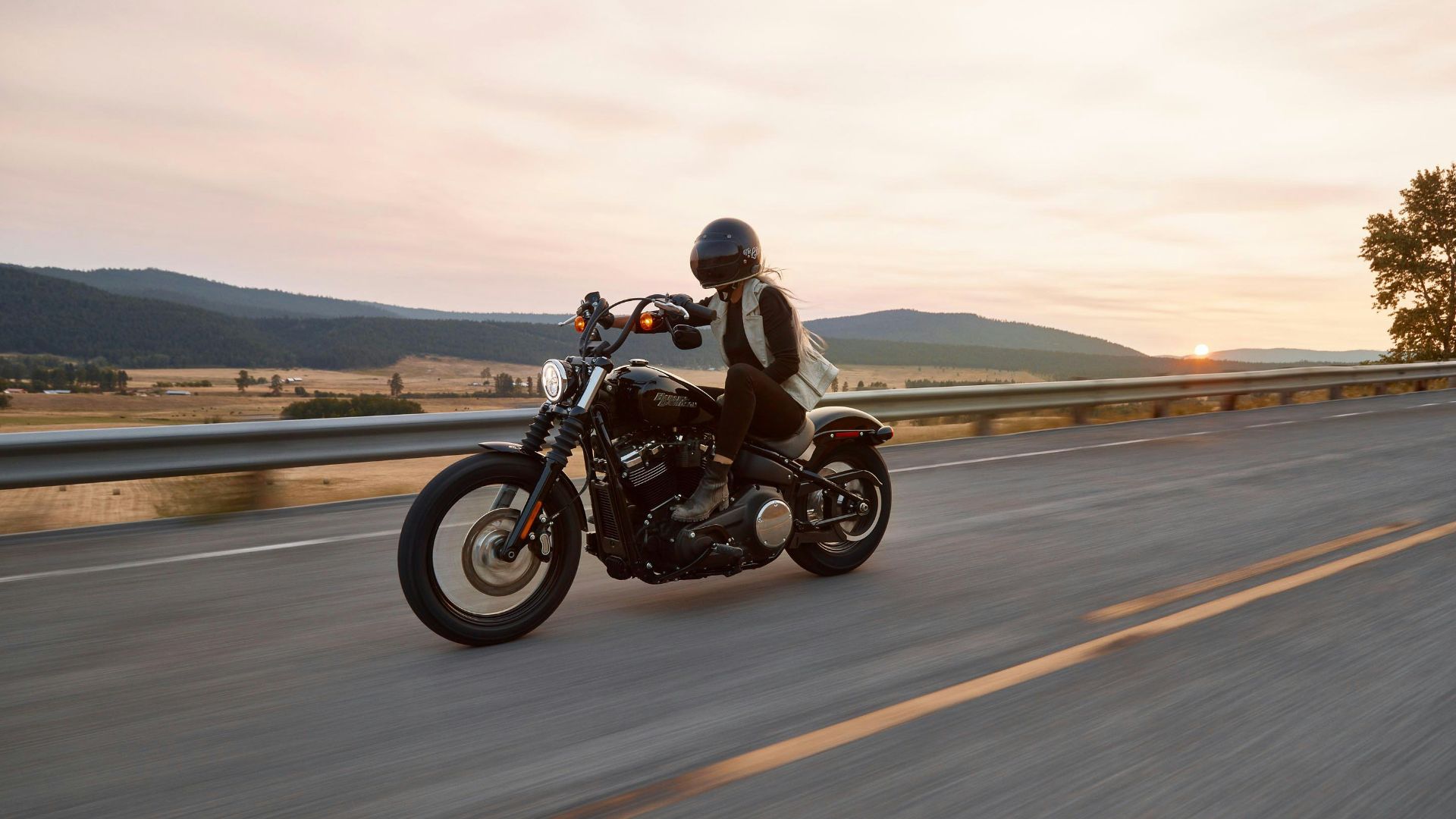 man on black cruiser motorcycle in highway