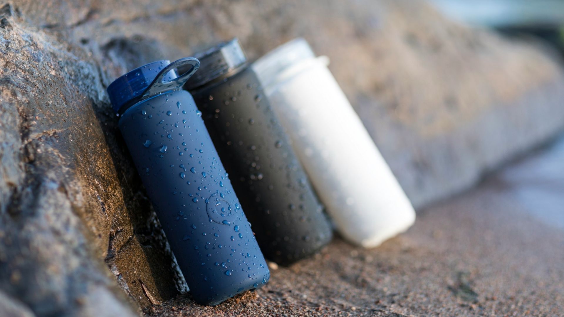 black and white plastic containers on brown sand