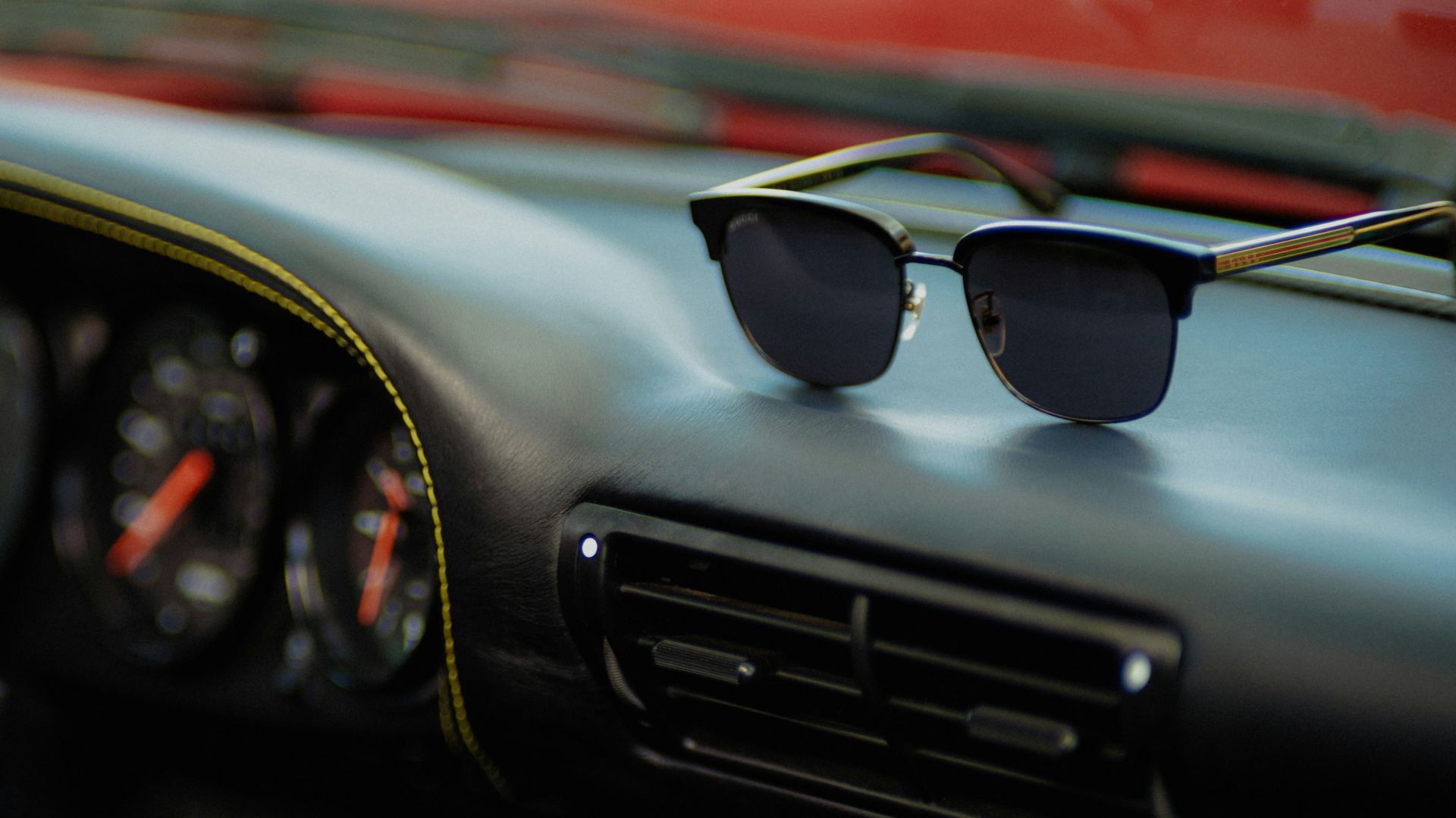 a pair of sunglasses sitting on the dashboard of a car