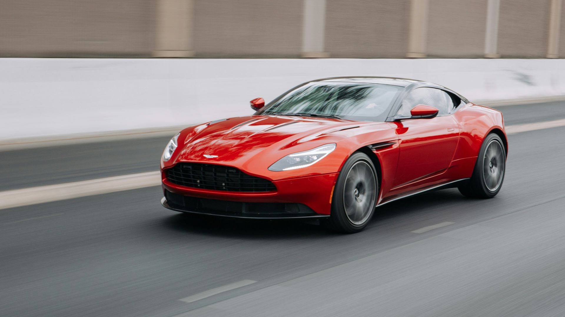 red coupe passing on road