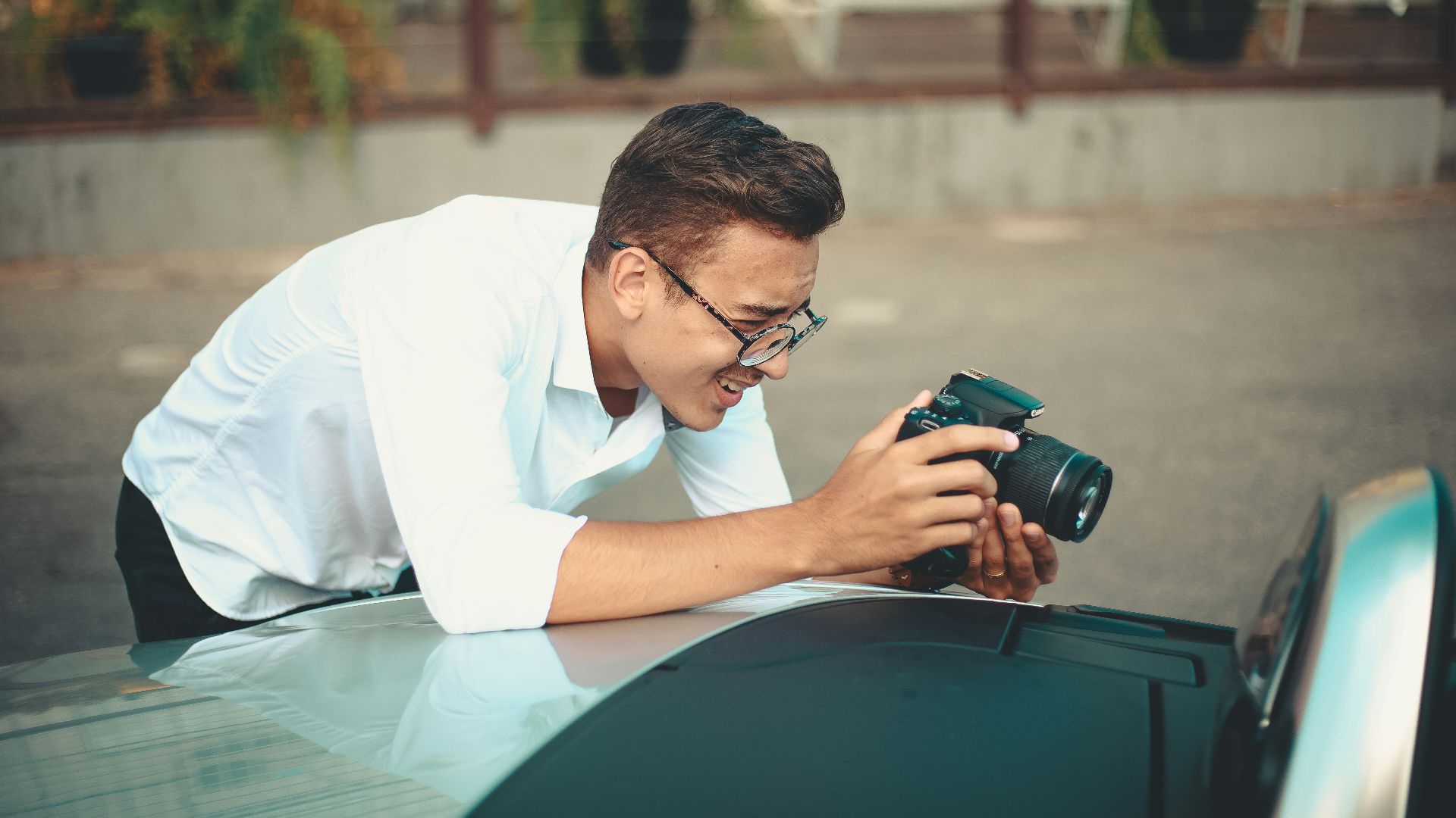 man using black DSLR camera