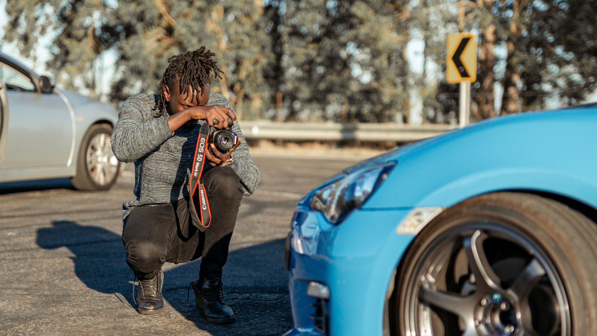 woman in black and white striped long sleeve shirt and blue denim jeans standing beside white
