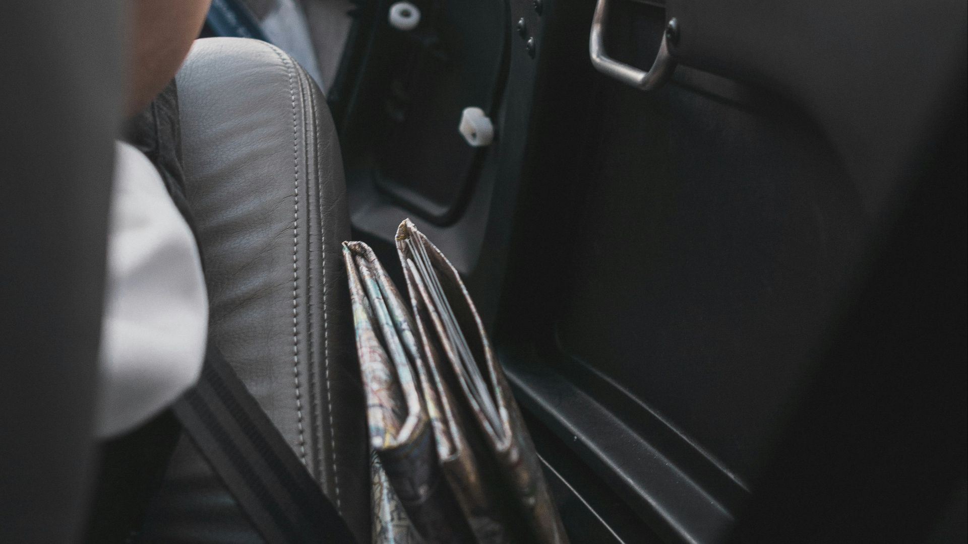 person sitting inside car beside door\