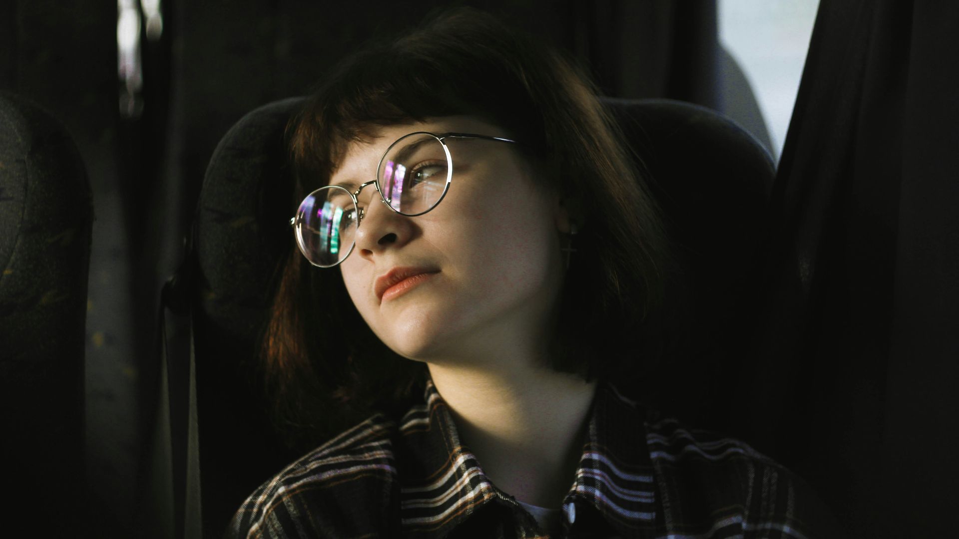 woman in black and white plaid dress shirt wearing eyeglasses